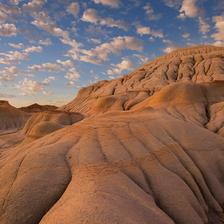 Very wrinkly rock formations from the Alberta Badlands under scattered clouds