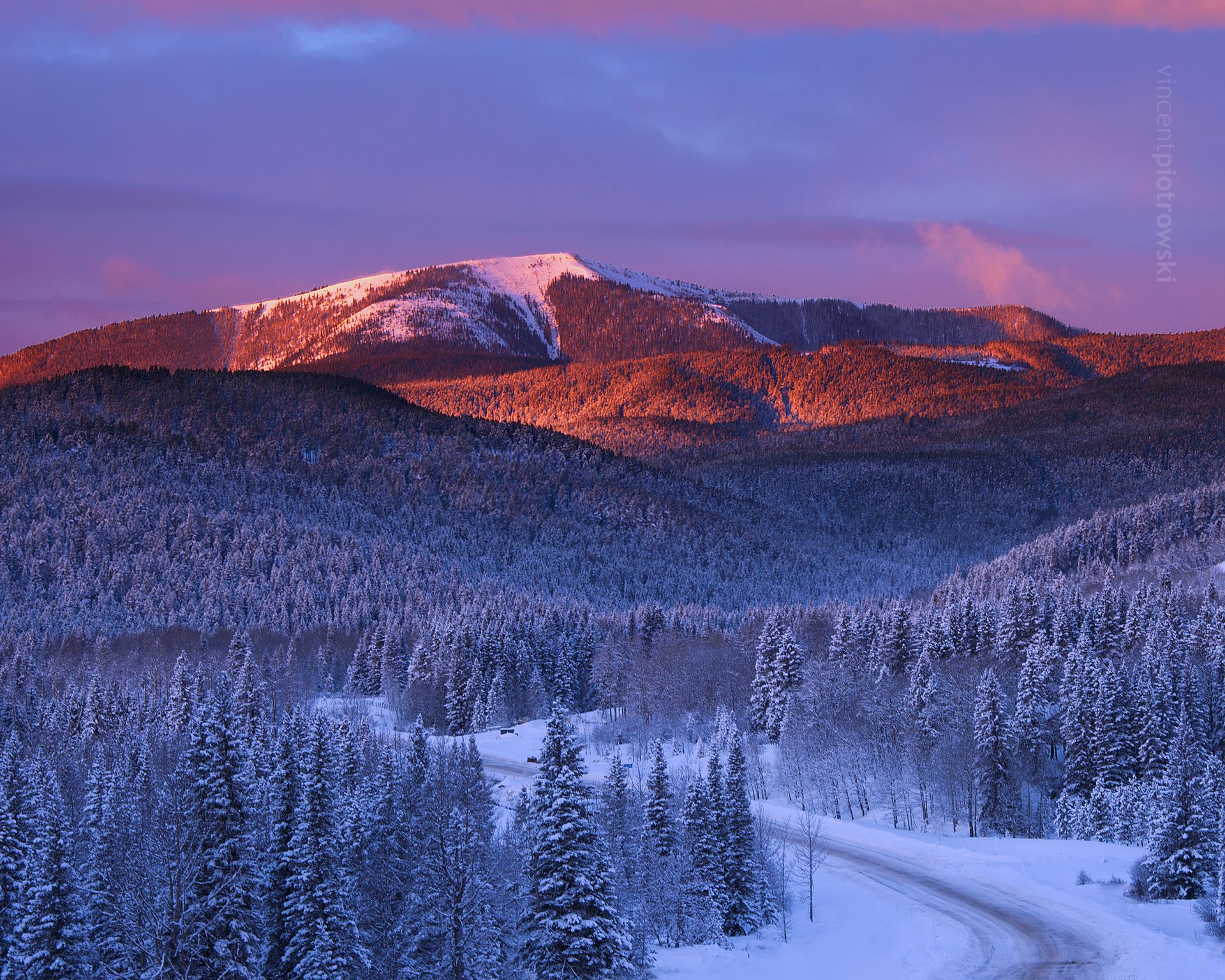 A winter sunrise over highway 66 with a heavy frost on the trees