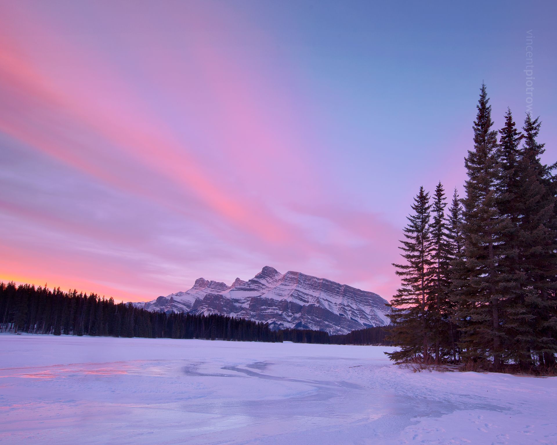 Two Jack Lake in Banff National Park in winter with Mt. Rundle in view