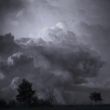A puffy mushroom shaped storm cloud rising above the prairies