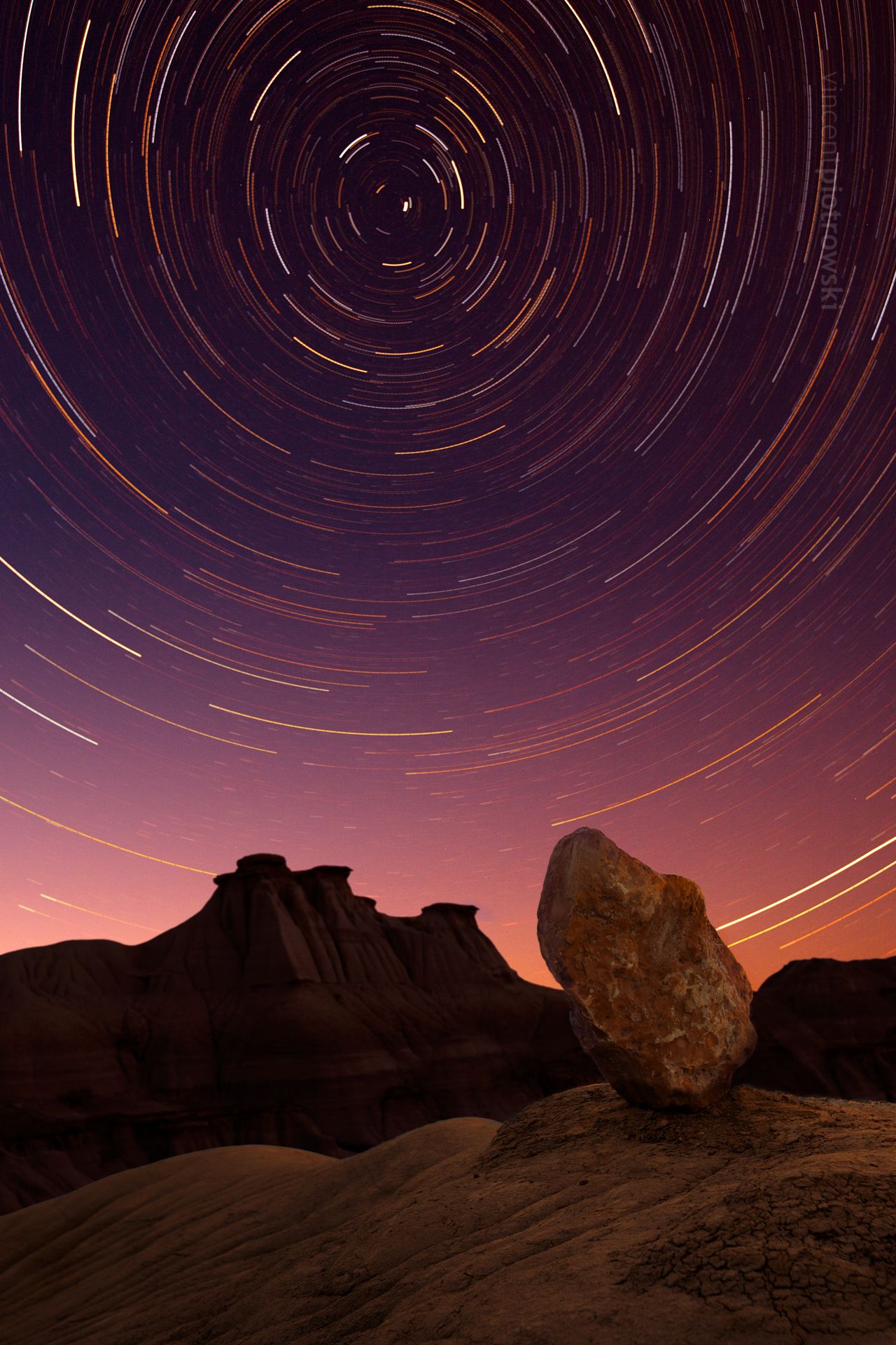 Star trails from a long exposure shot capture over the Alberta Badlands