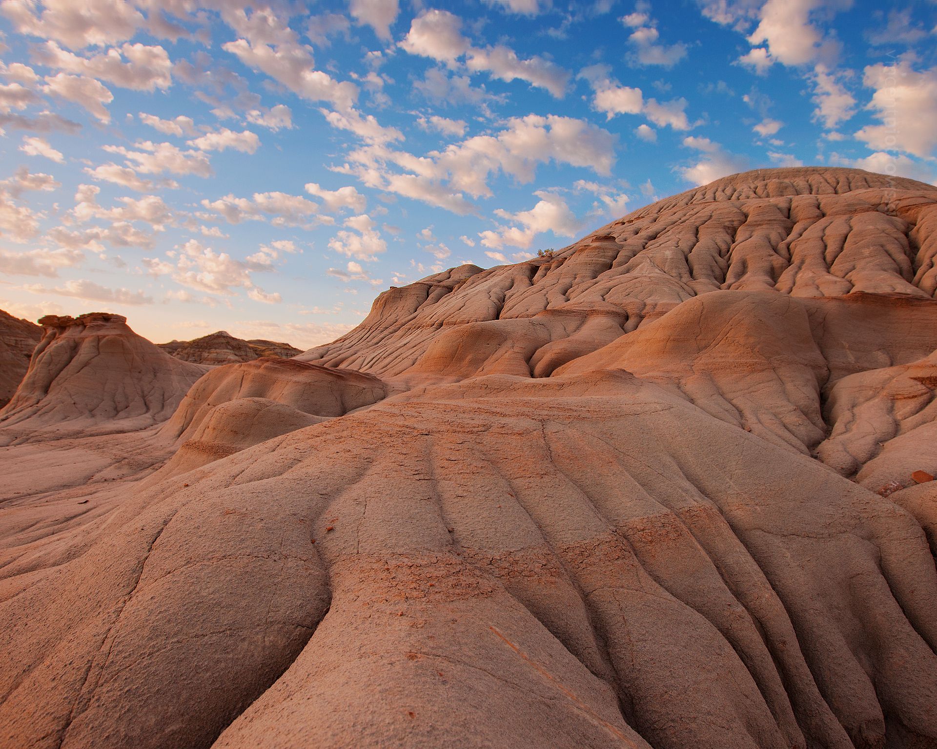 Very wrinkly rock formations from the Alberta Badlands under scattered clouds