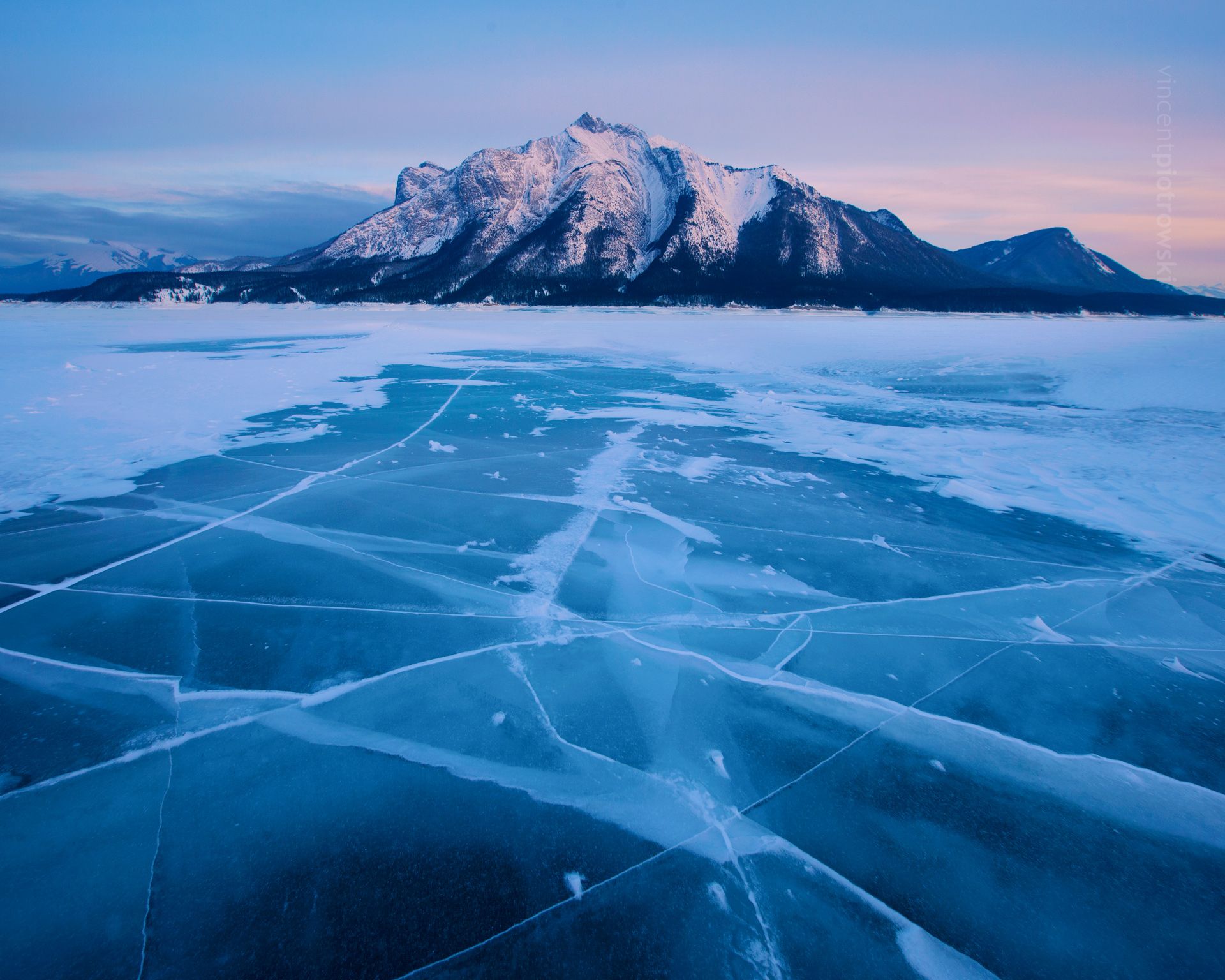 Cracks in the ice on Abraham Lake with Mt Michener in the background