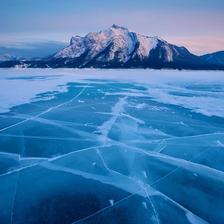 Cracks in the ice on Abraham Lake with Mt Michener in the background