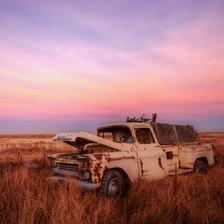 An old beat up 59 chevy truck in a field at sunset