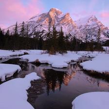 Wintery photograph of Mt Kidd reflected in a natural spring at sunrise