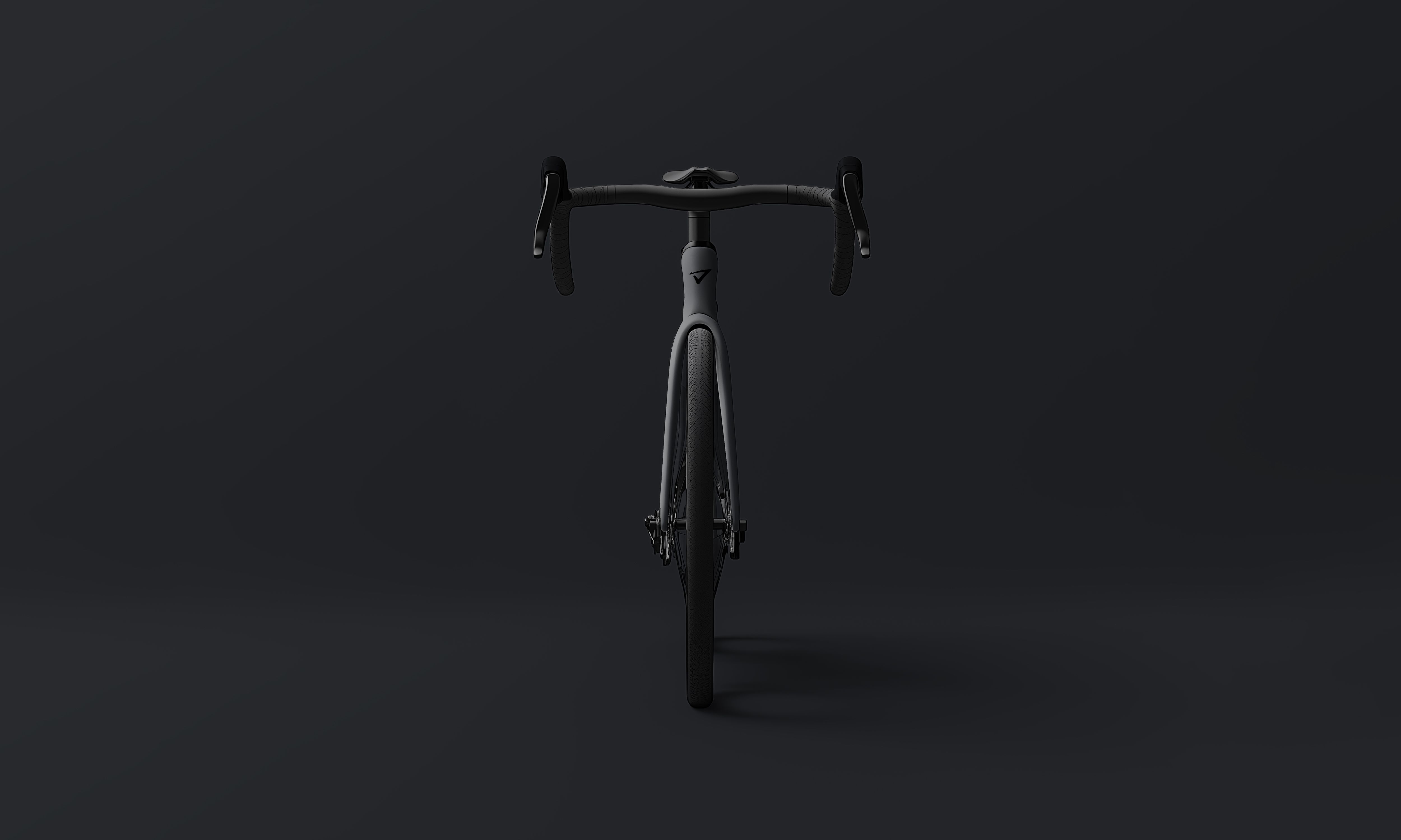 a black bicycle is sitting on a black surface .