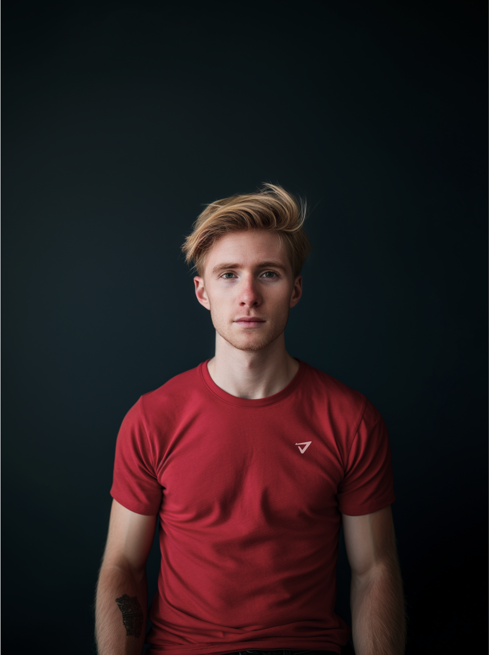 a man wearing a red t-shirt with an arrow on it