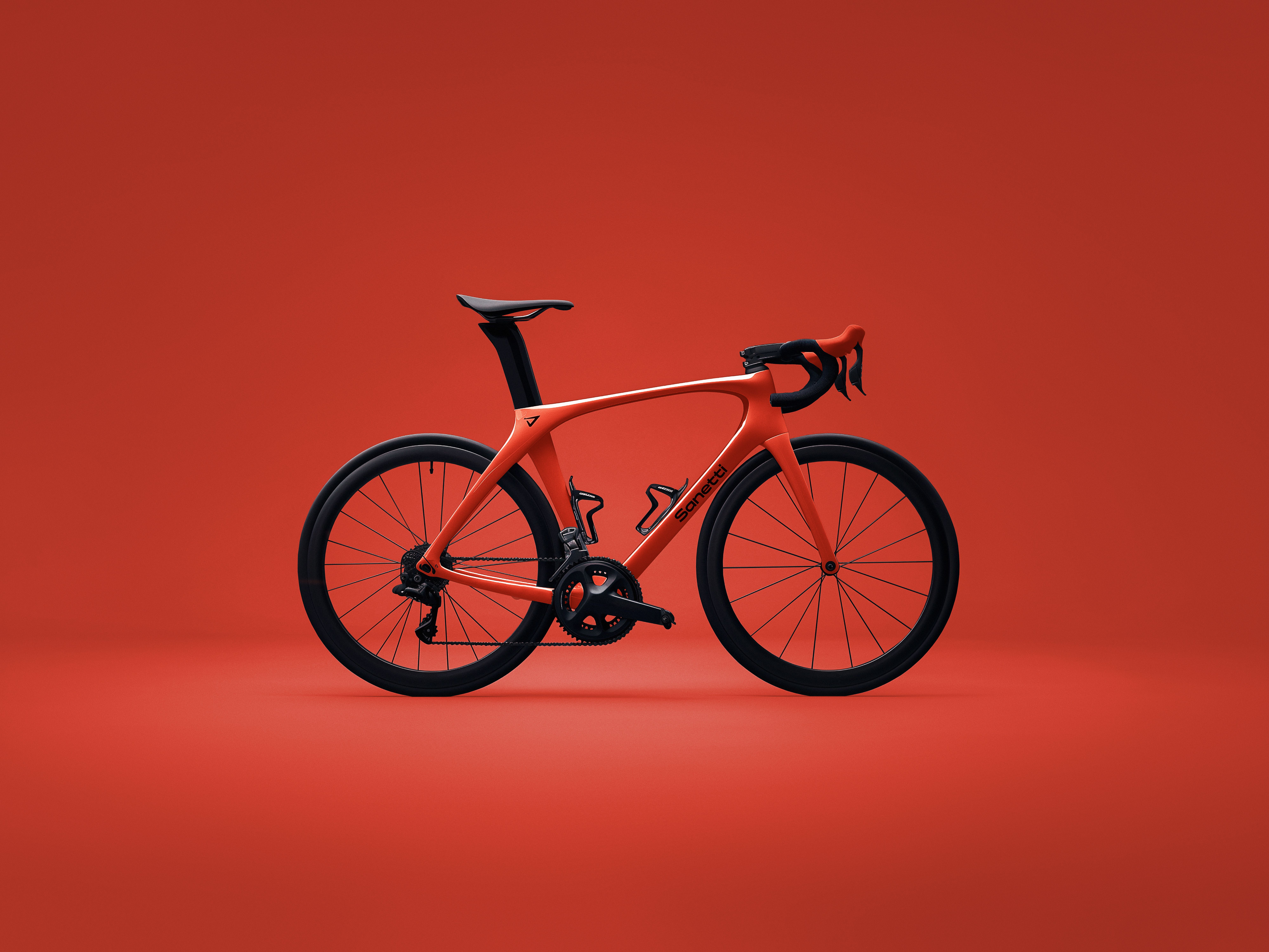 a red bicycle is sitting on a red background .