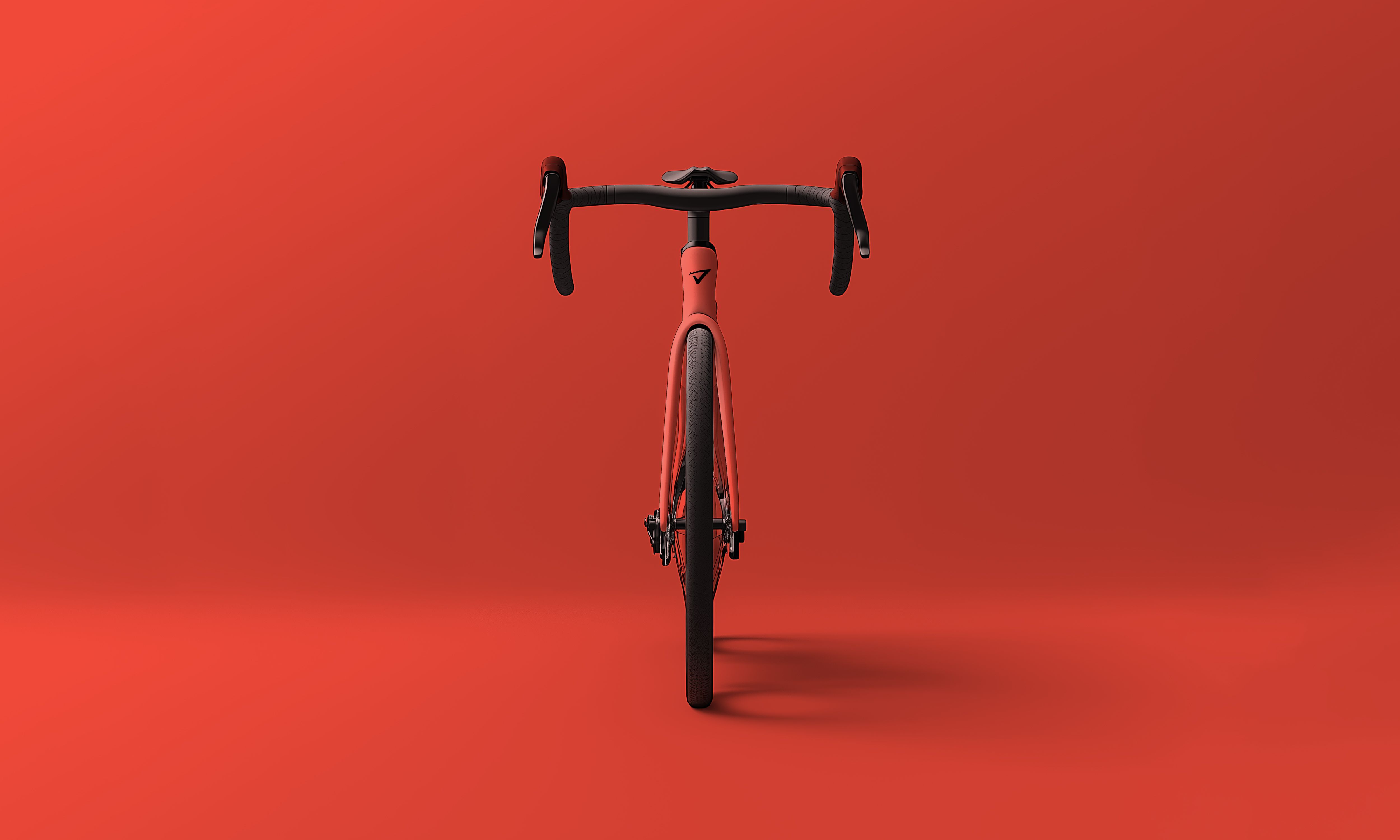 a red bicycle is sitting on a red surface .