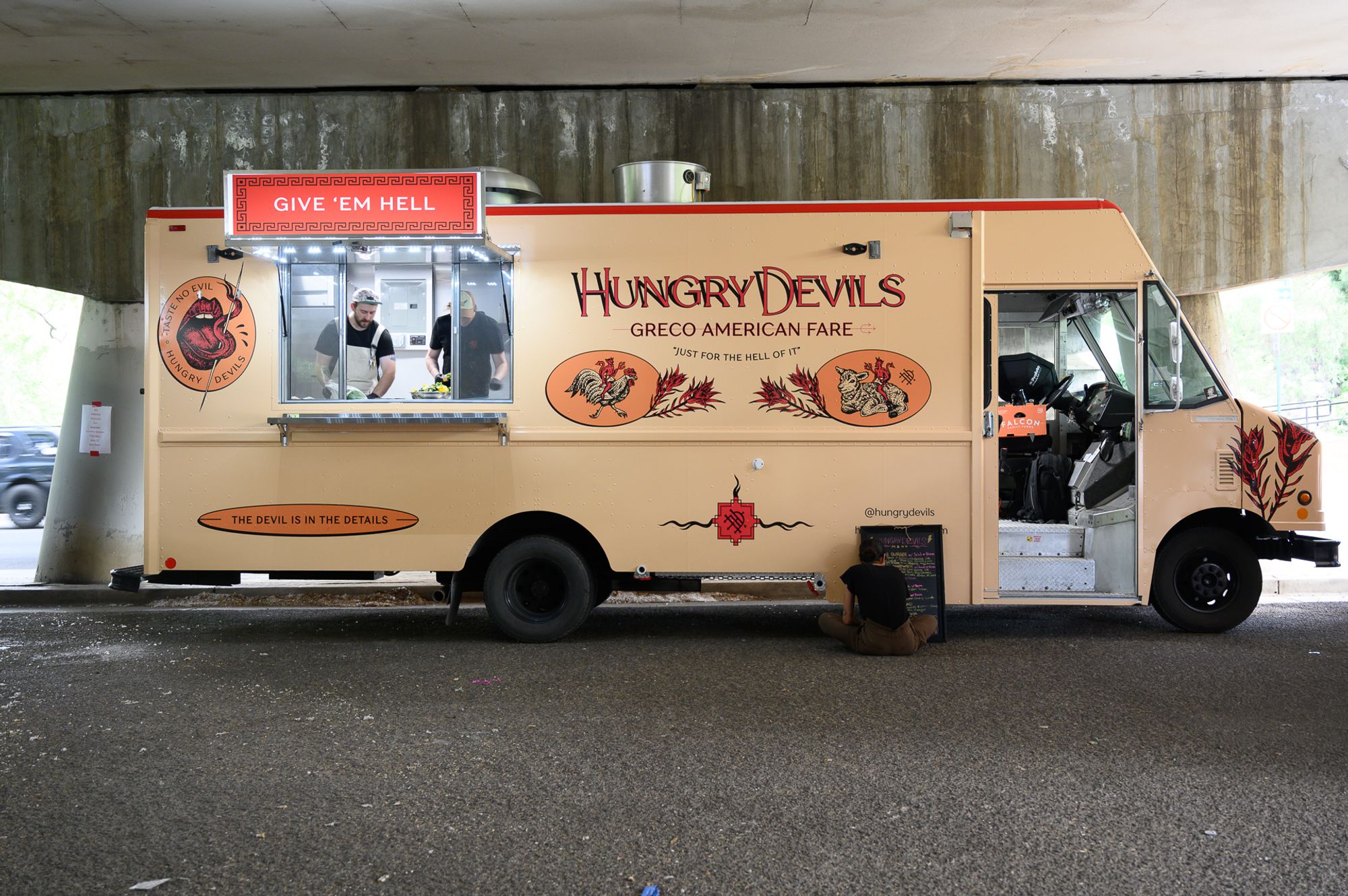 Owners serving food from Hungry Devils food truck