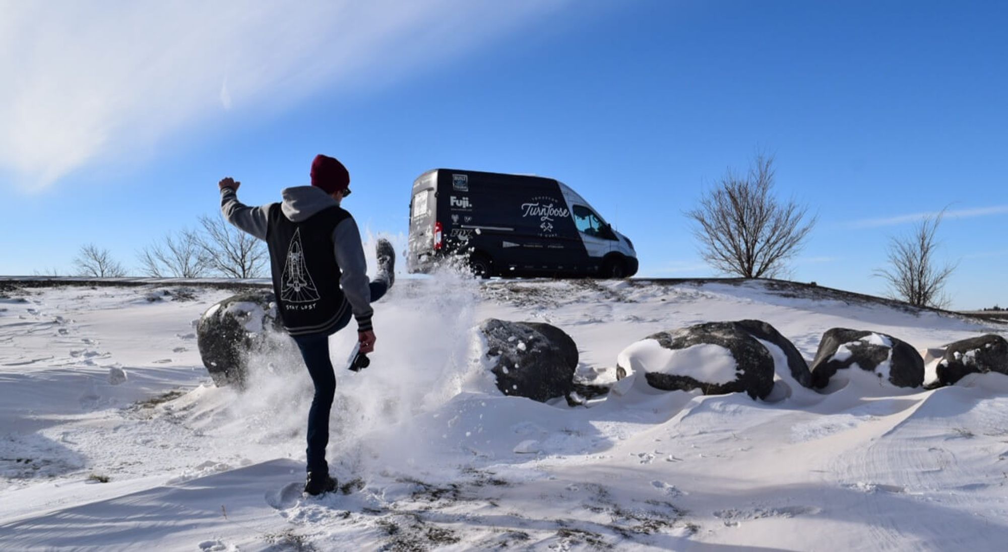 Man kicking snow
