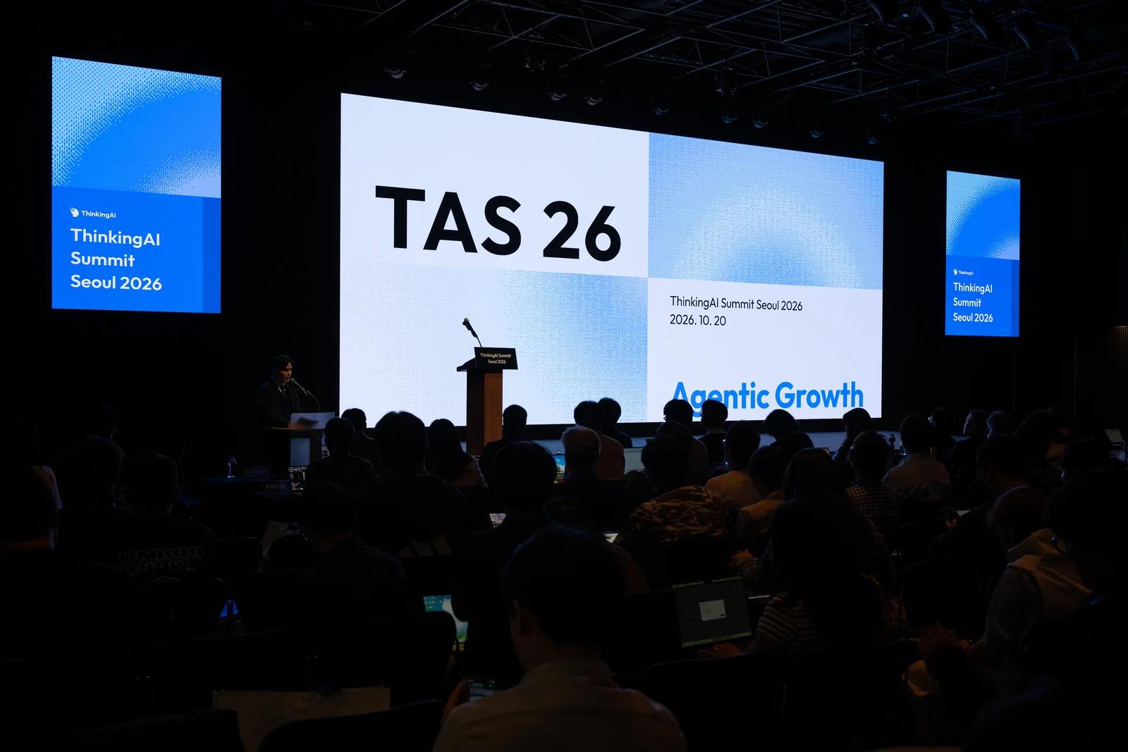 The full hall at ThinkingAI Summit Seoul 2026 facing the main stage, with TAS 26 on screen.