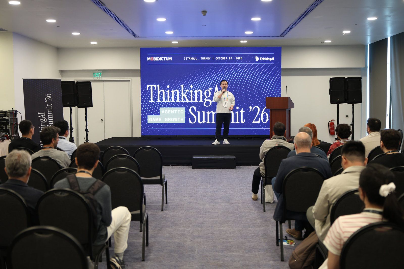 Jerry Jiang on stage in front of the full room