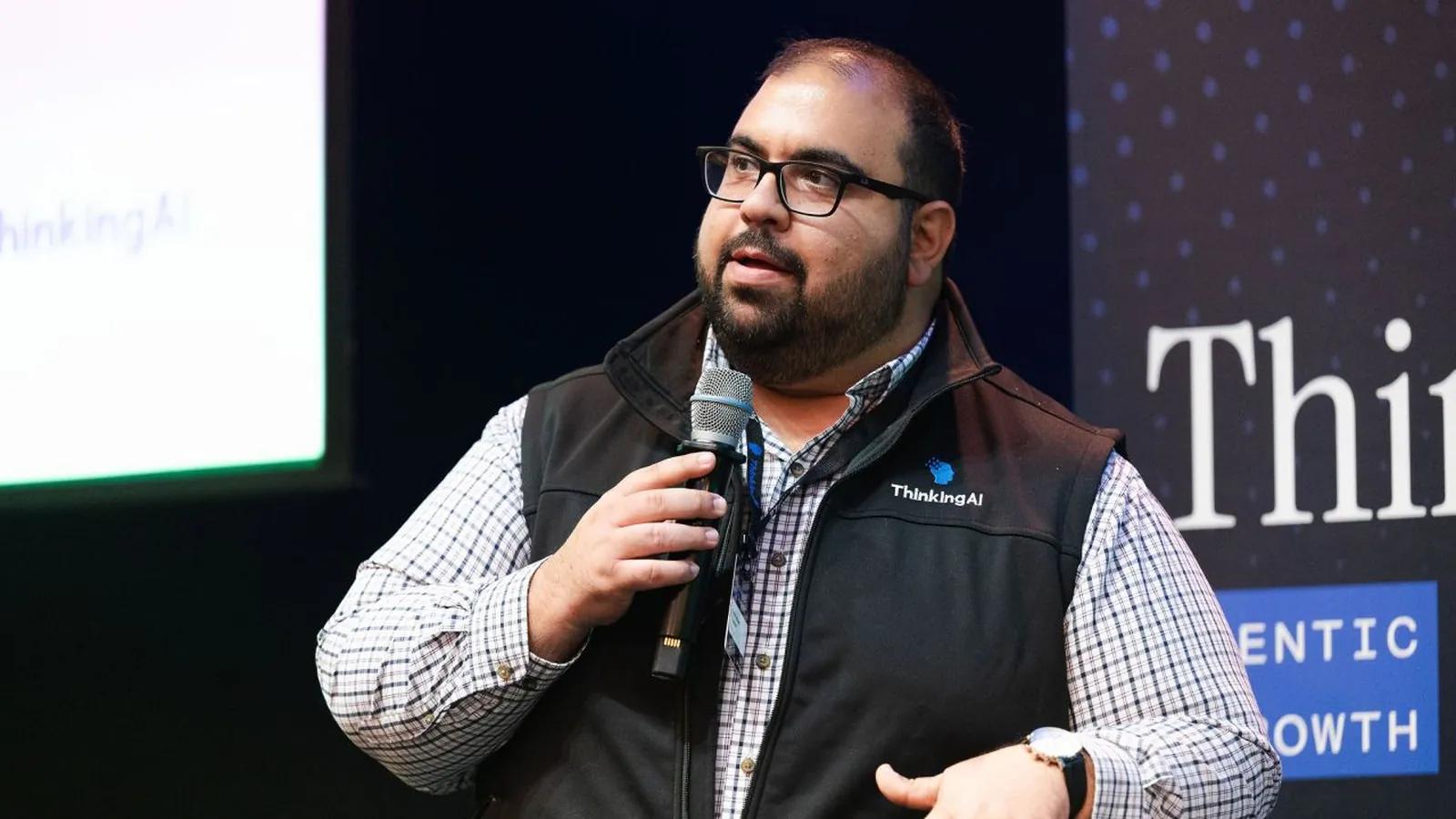 Brandon Nader, VP of Marketing at ThinkingAI, speaking with a microphone at ThinkingAI Agentic Growth Summit