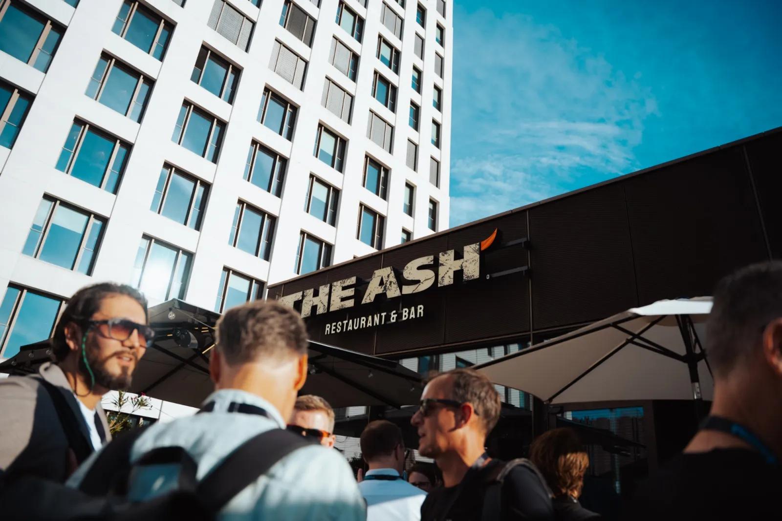 Guests arriving outside THE ASH restaurant and bar in Cologne on a sunny afternoon