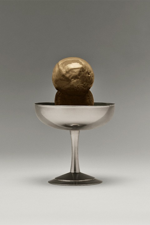 A bowl of two scoops of hojicha ice cream.