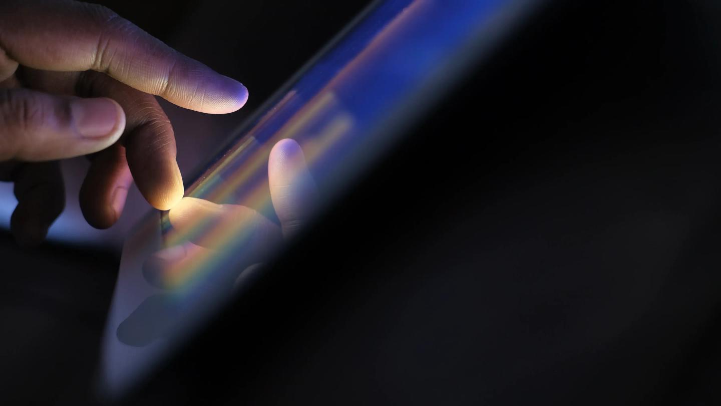 Hand interacting with colorful digital screen interface
