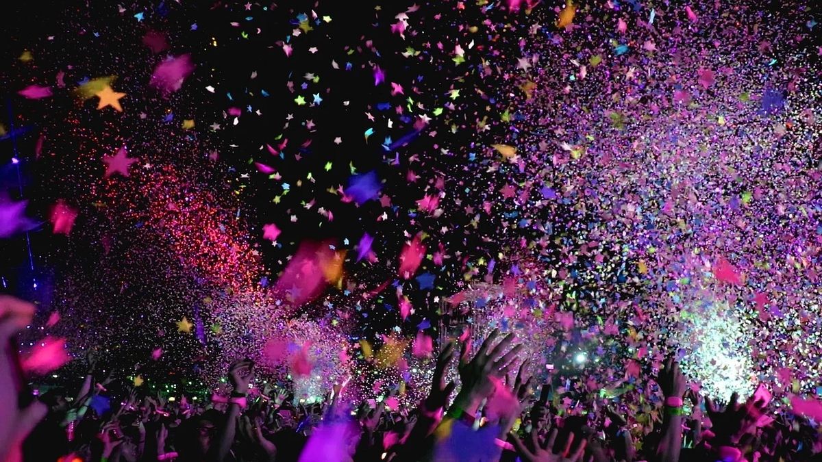 A celebration with confetti and hands in the air