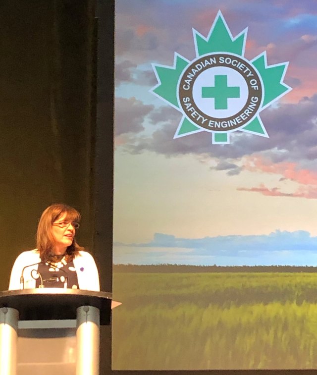 Louise Hosking speaking at a podium