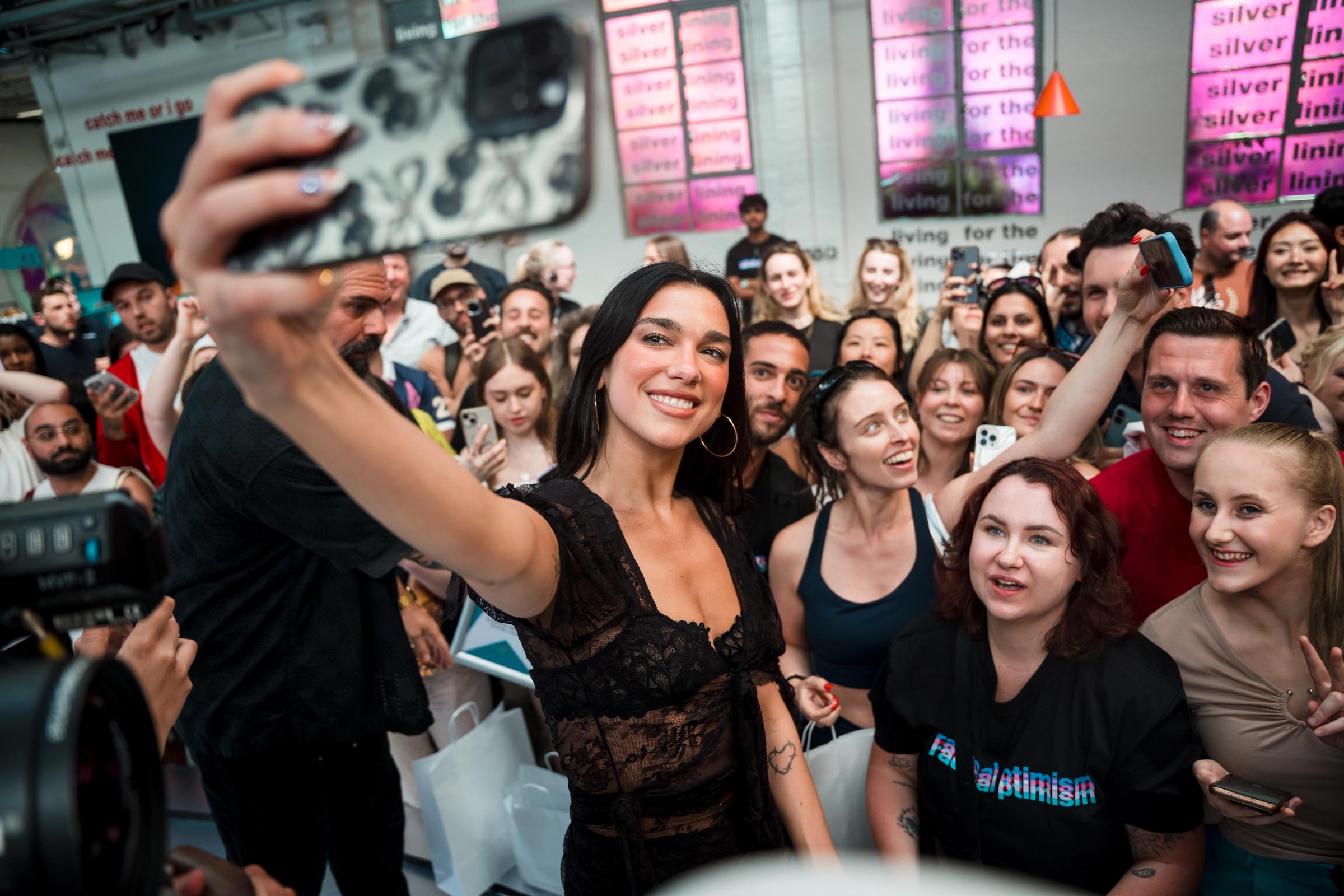 Dua Lipa with fans at the Radical Optimism pop-up store in London