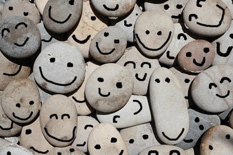 GIF of pebbles with smiling faces