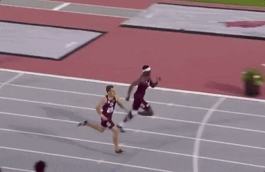 GIF of a man sprinting and jumping to the finish line
