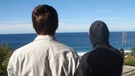 Two men staring out at the ocean