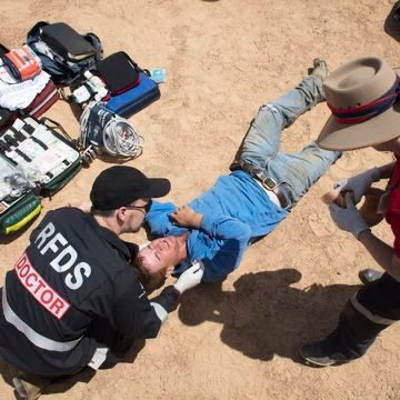 Image of Royal Flying Doctor Service helping injured man in Outback NSW