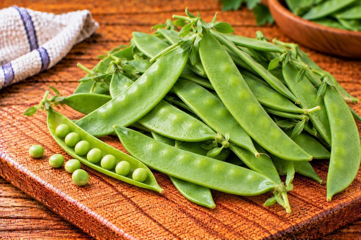 Flat green snow pea pods with smooth, crisp-looking surfaces