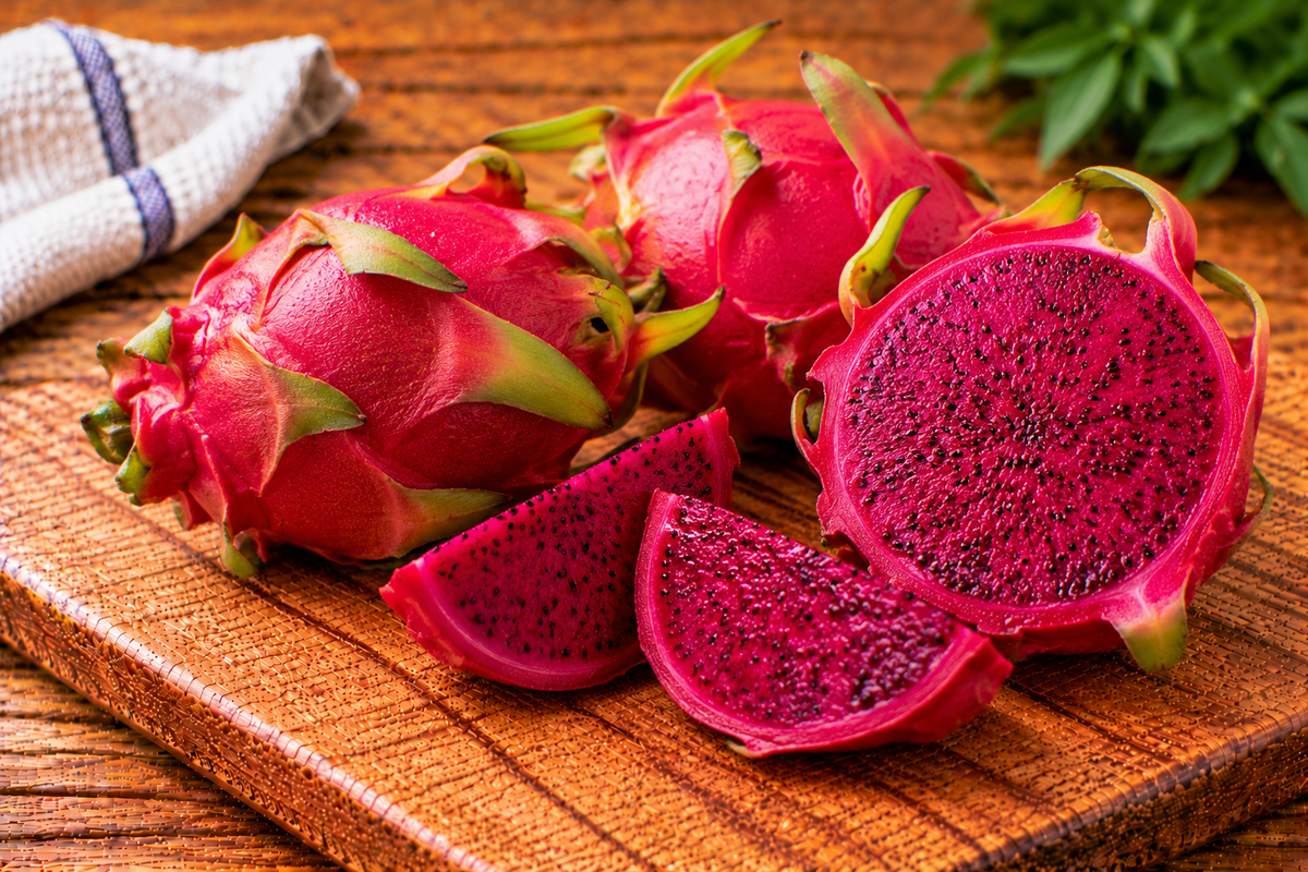 Red dragon fruit with magenta skin and green-tipped scales