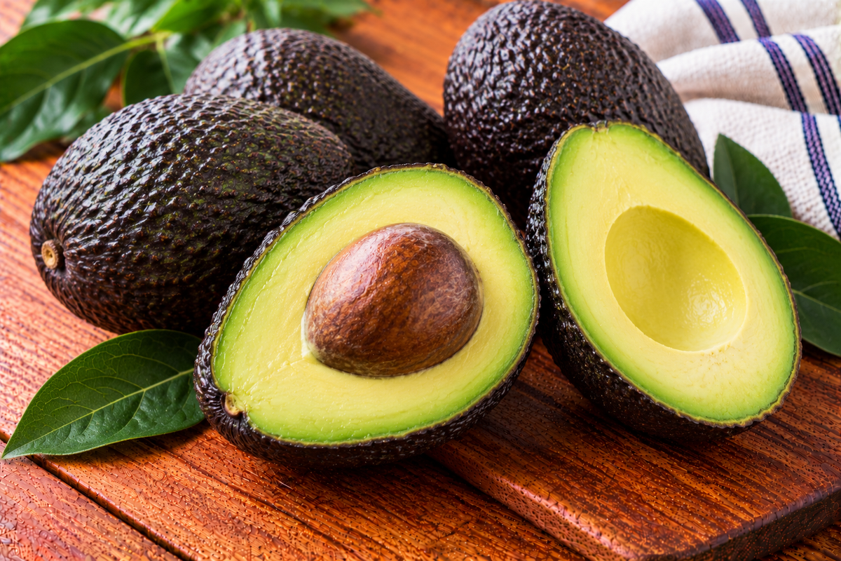 Hass avocado with pebbled dark skin and creamy green flesh