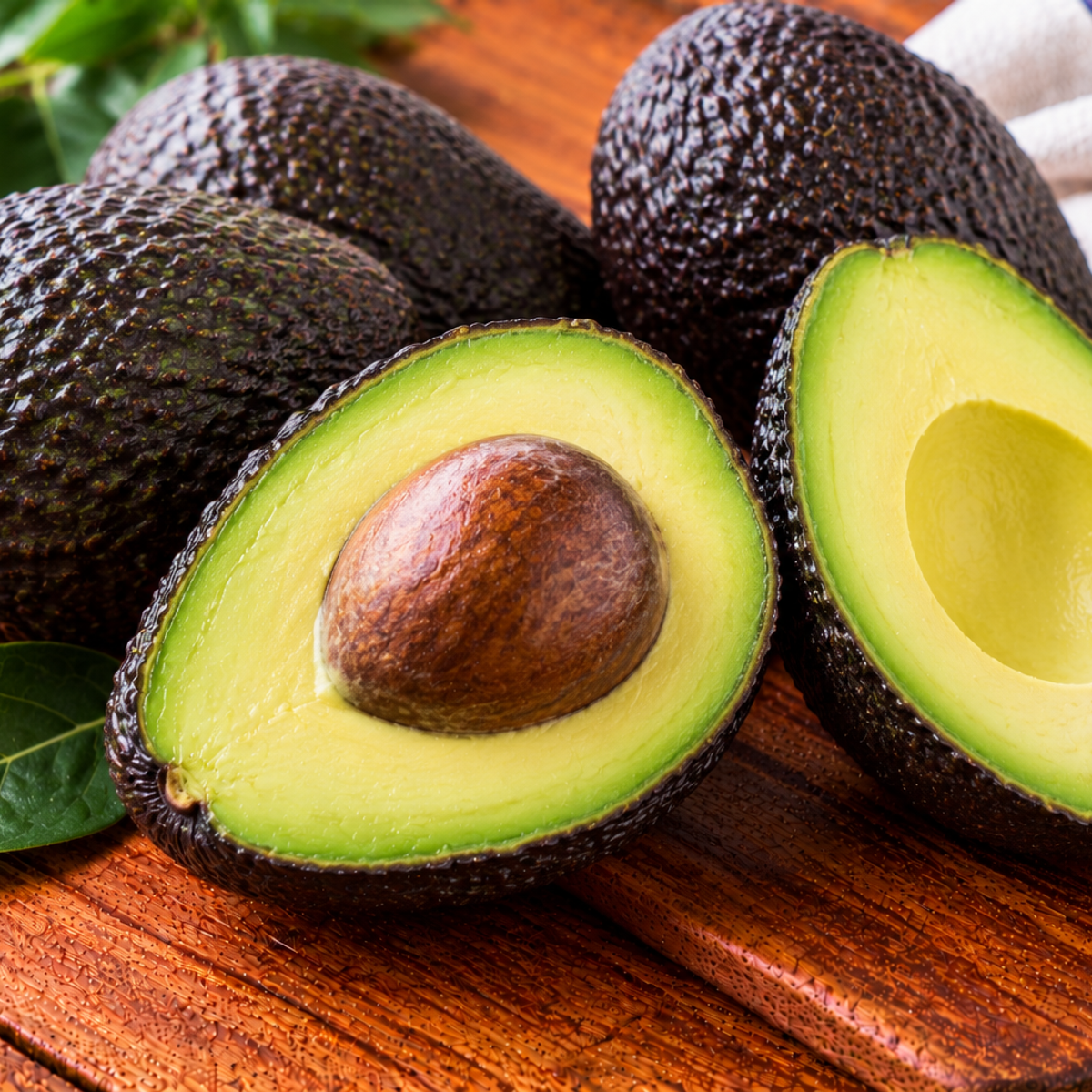 Hass avocado with pebbled dark skin and creamy green flesh