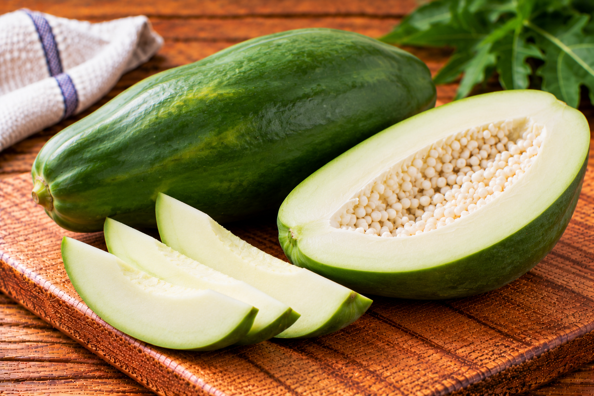 Unripe papaya with green skin and firm pale flesh