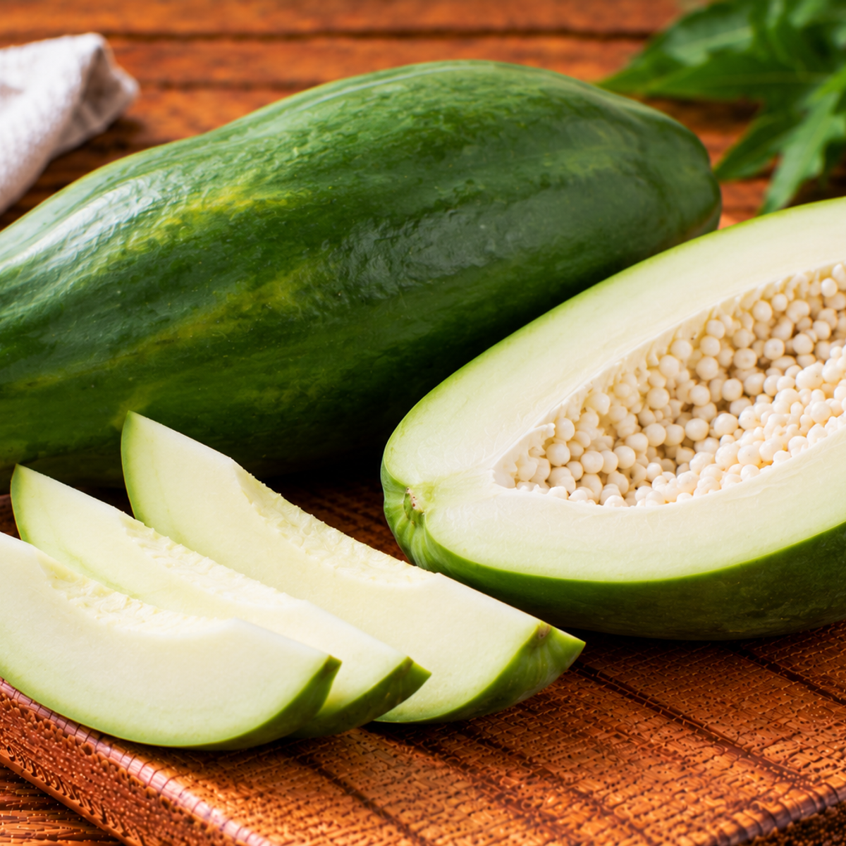 Unripe papaya with green skin and firm pale flesh