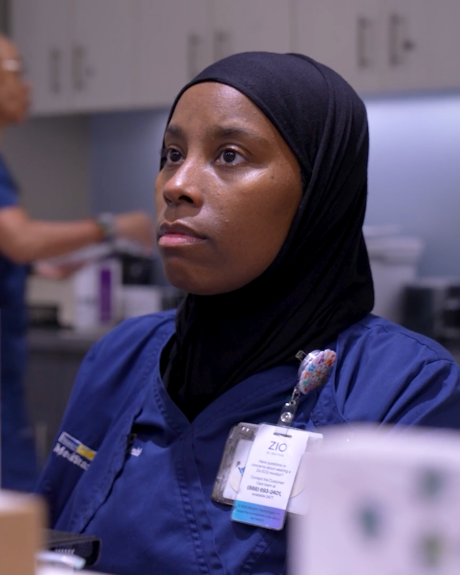 A clinical team member at her workstation in a cardiology practice