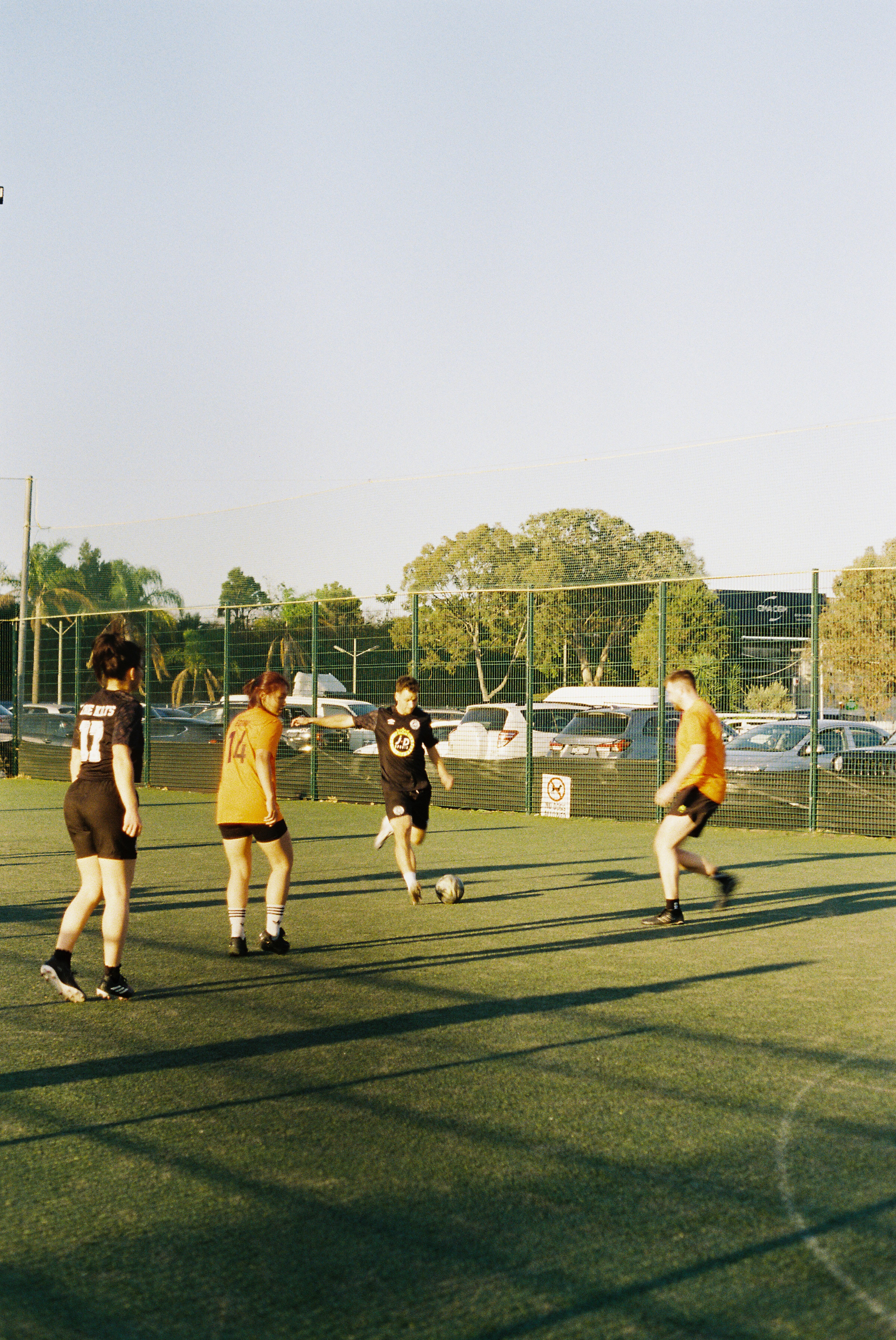 Players competing on a football pitch during an Off Season tournament match