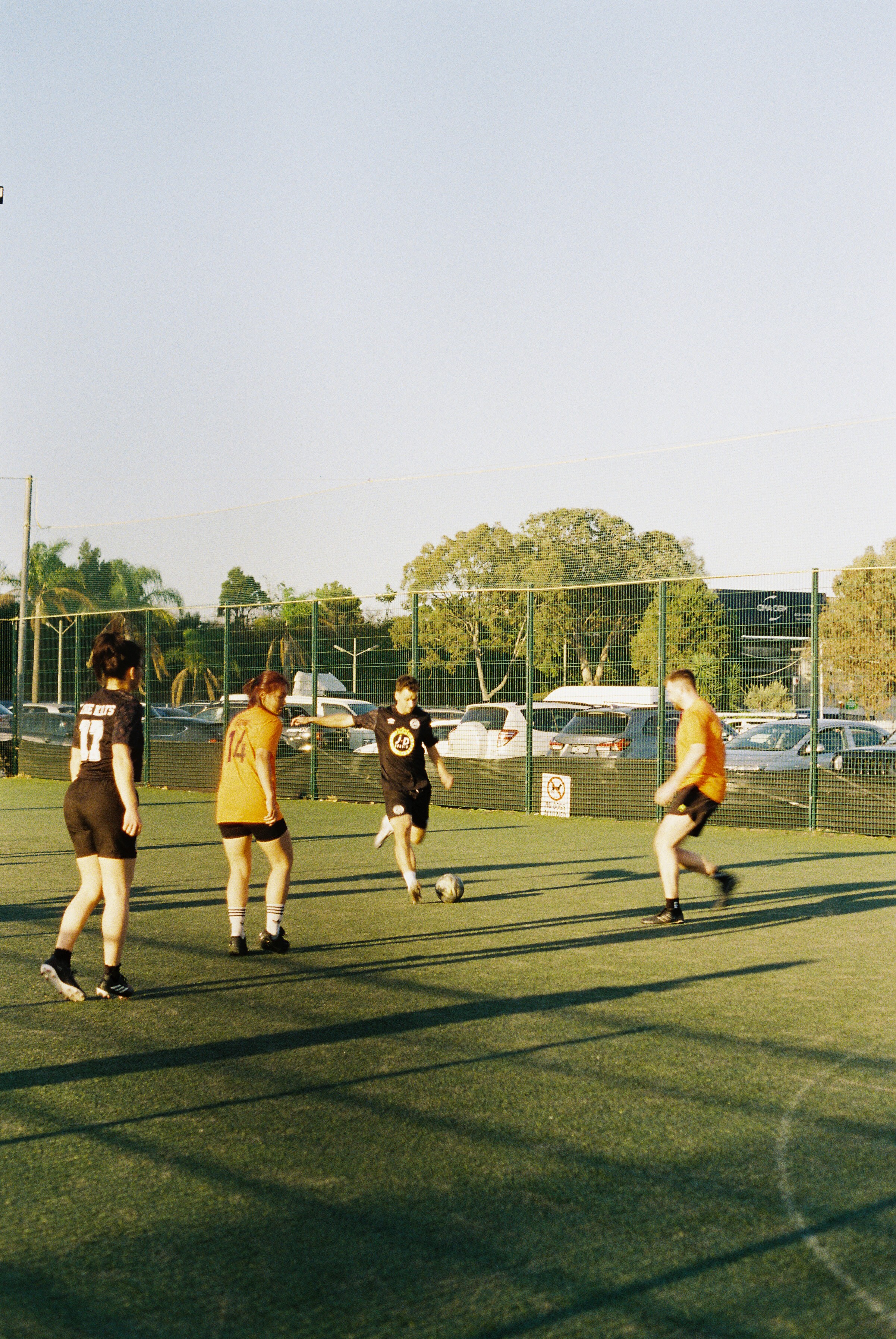 Players competing on a football pitch during an Off Season tournament match
