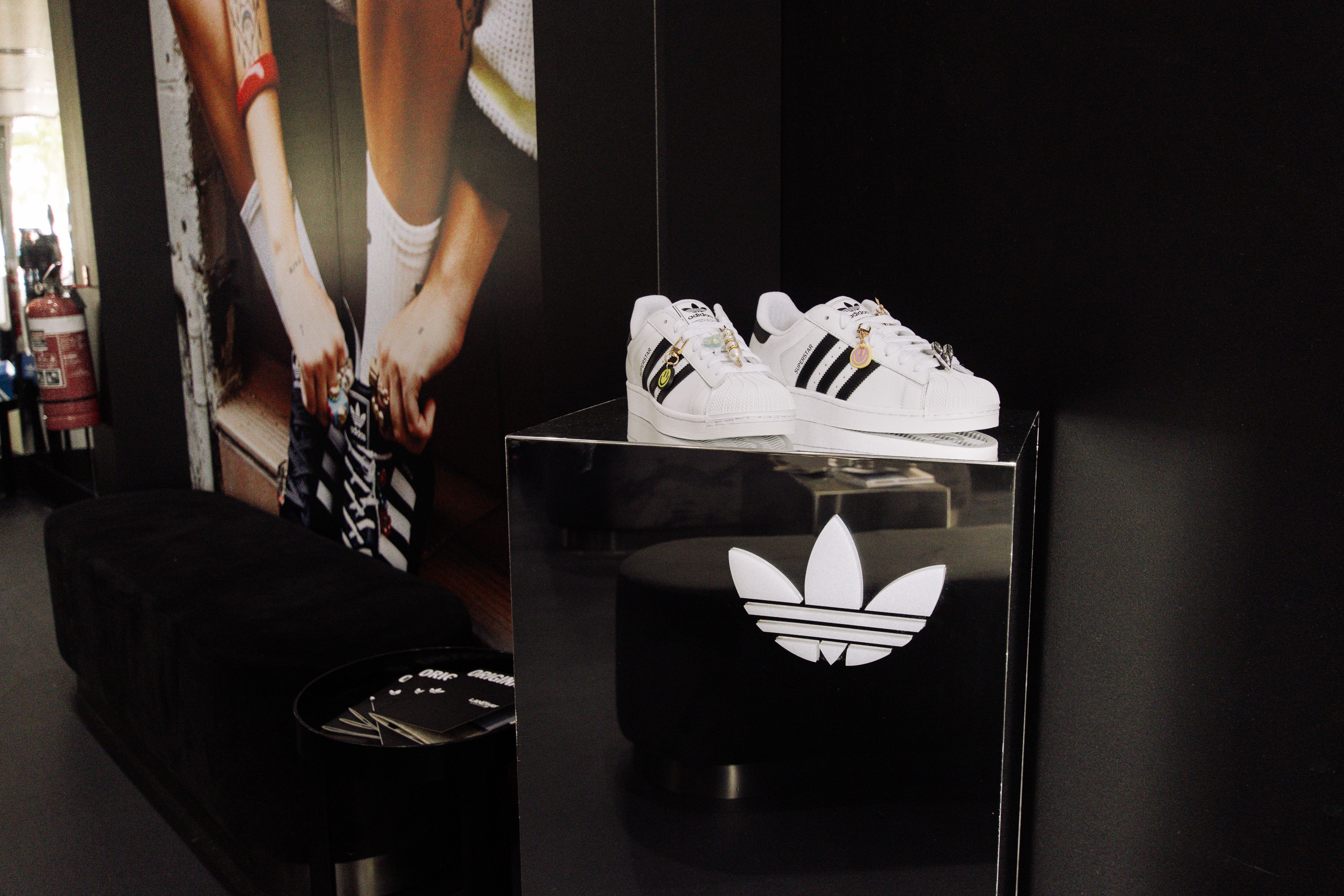The adidas Clubhouse at Laneway Festival — a black shipping-container activation wrapped in a bold monochrome adidas Originals trefoil print, set on the grass under open sky