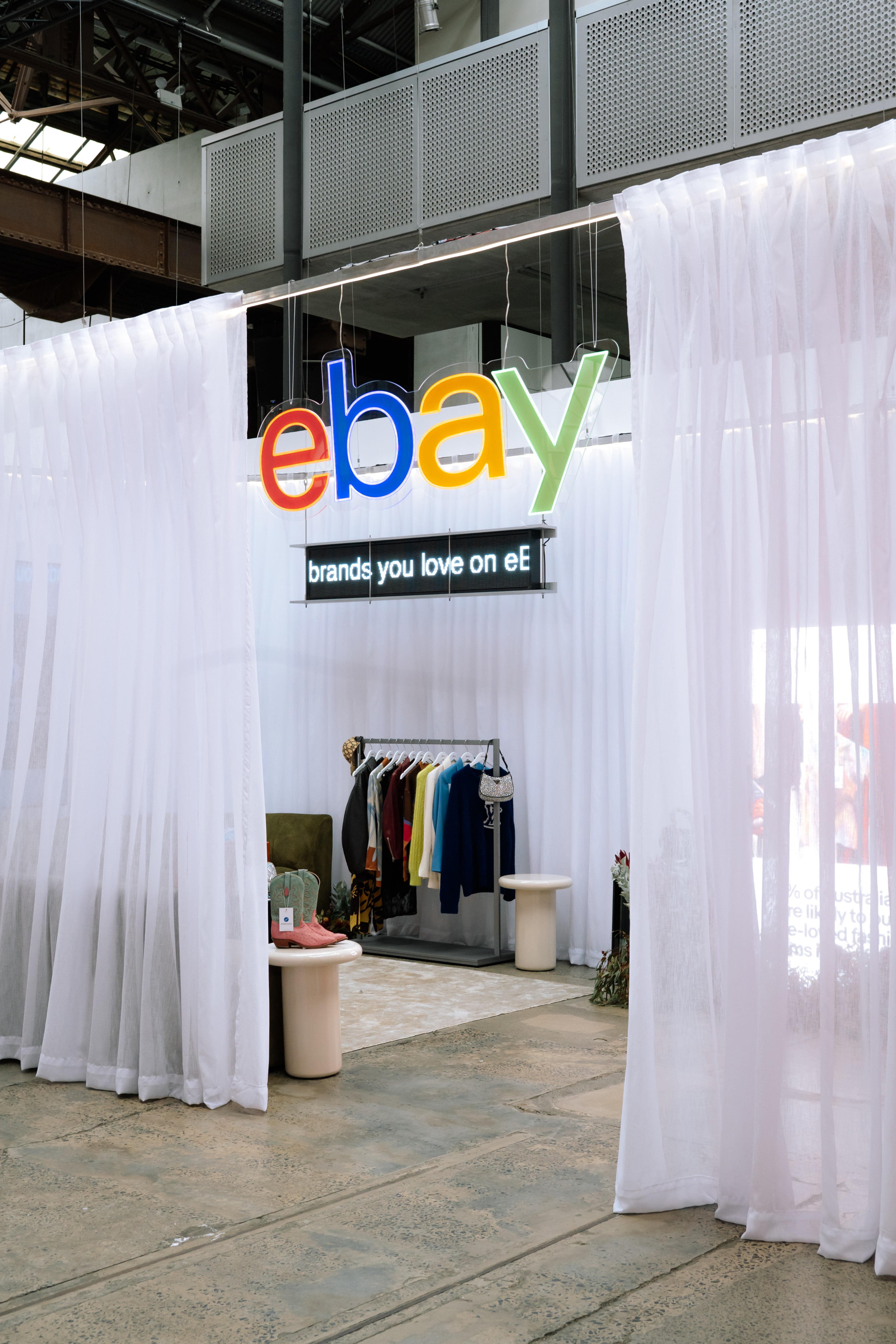 eBay logo signage above a sheer curtained activation space at Carriageworks
