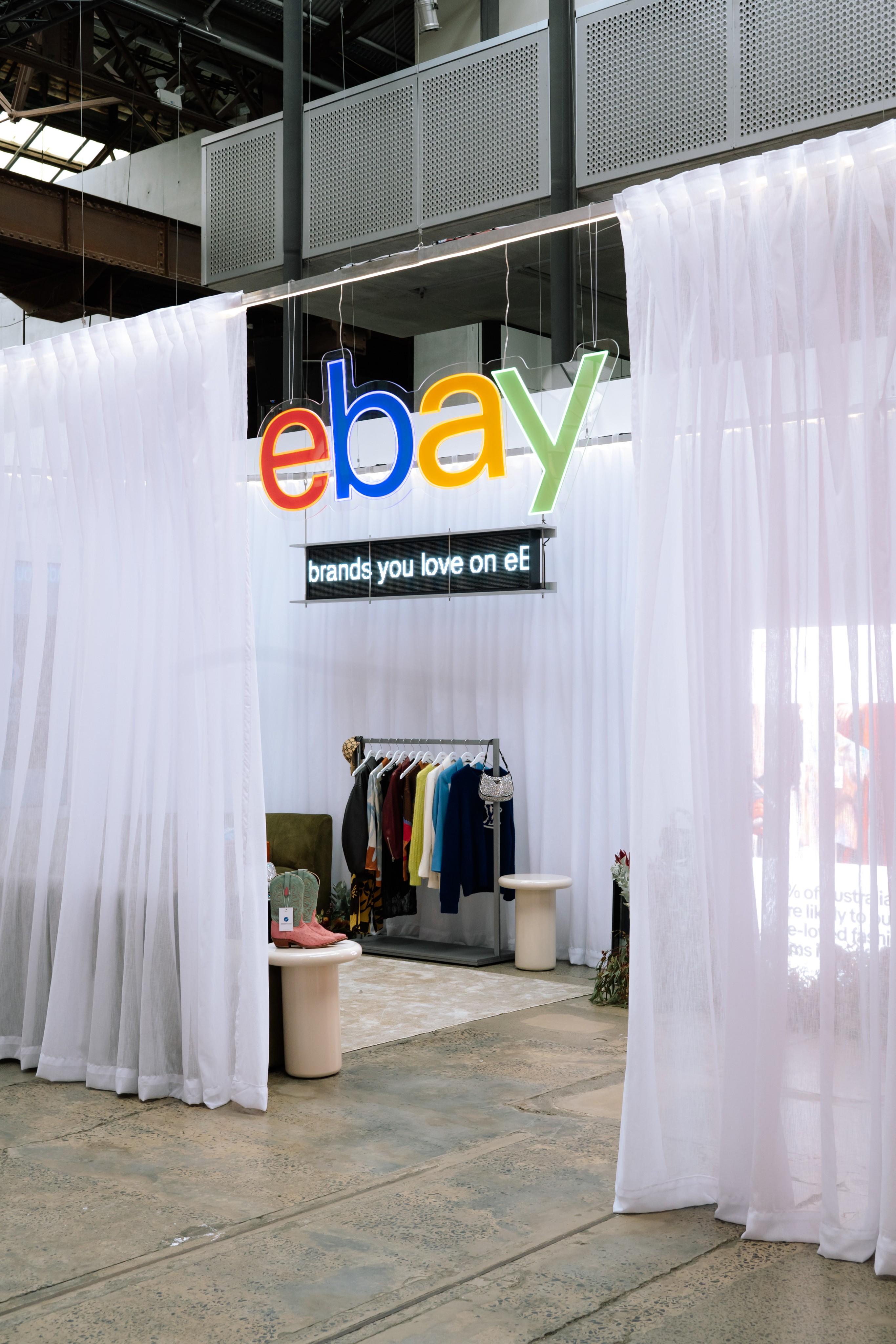 eBay logo signage above a sheer curtained activation space at Carriageworks