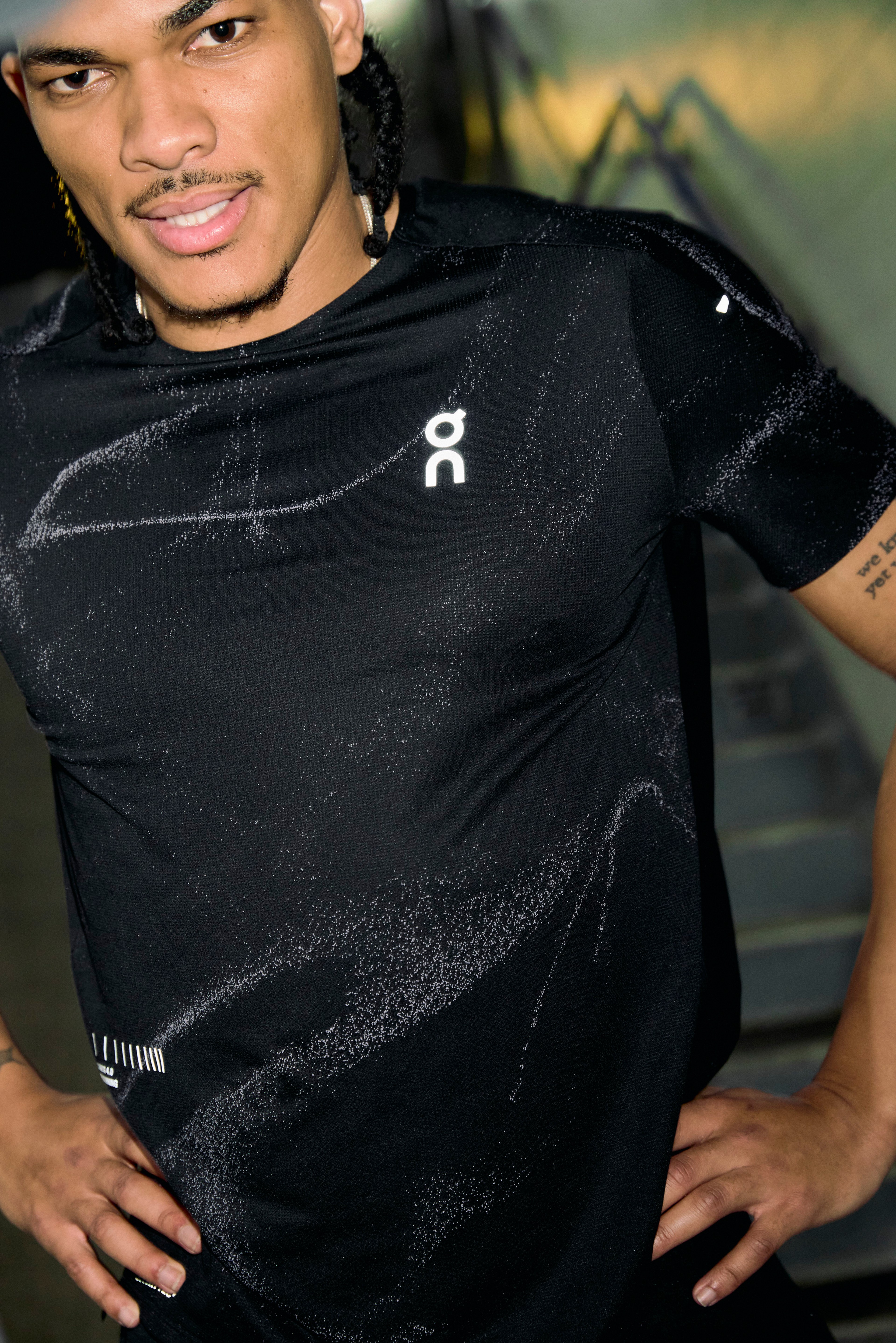Portrait of an athlete in an On top with the brand logo, shot outdoors at dusk