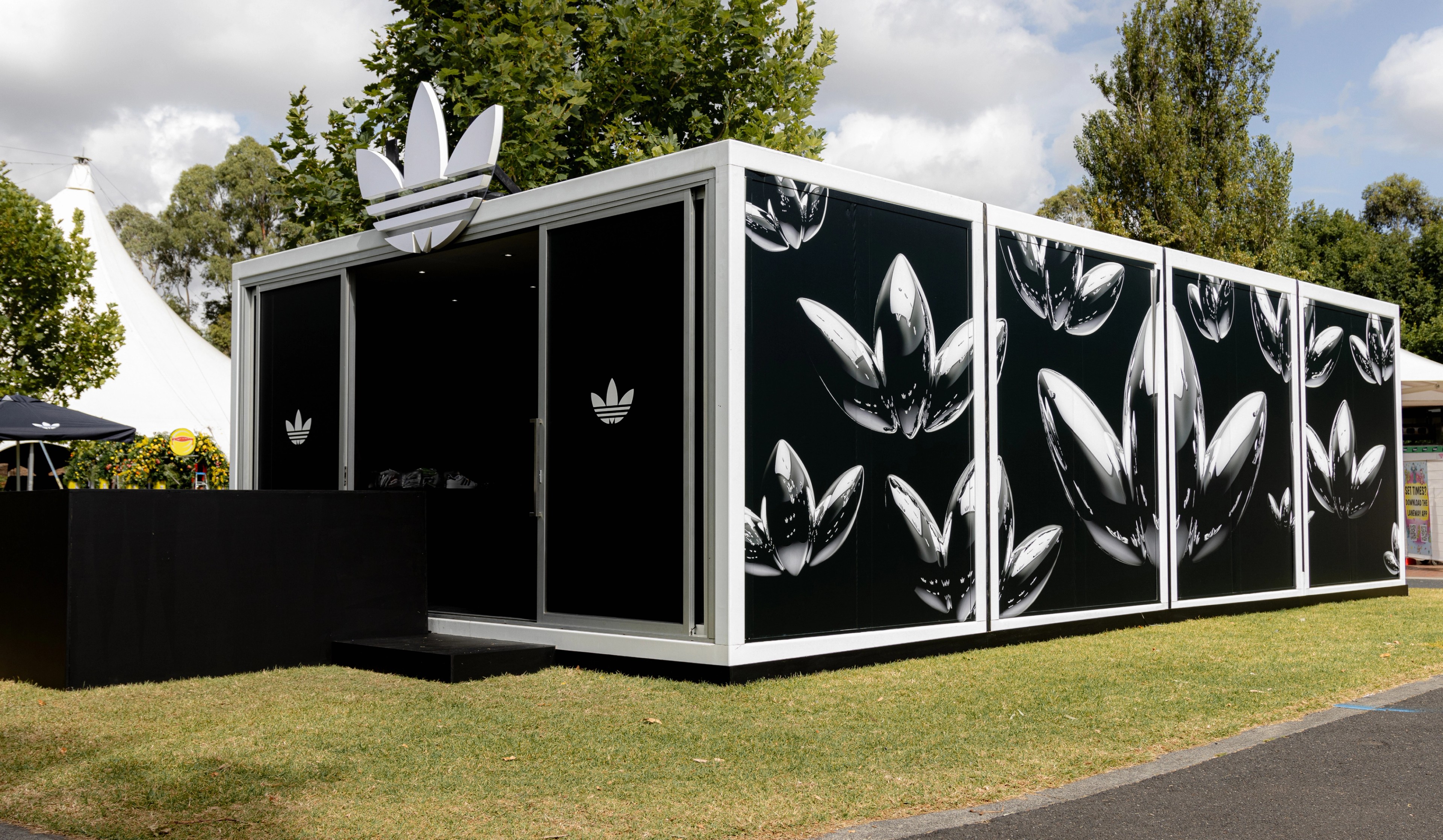 adidas Originals pop-up structure at Laneway Festival with chrome trefoil graphics on black panels