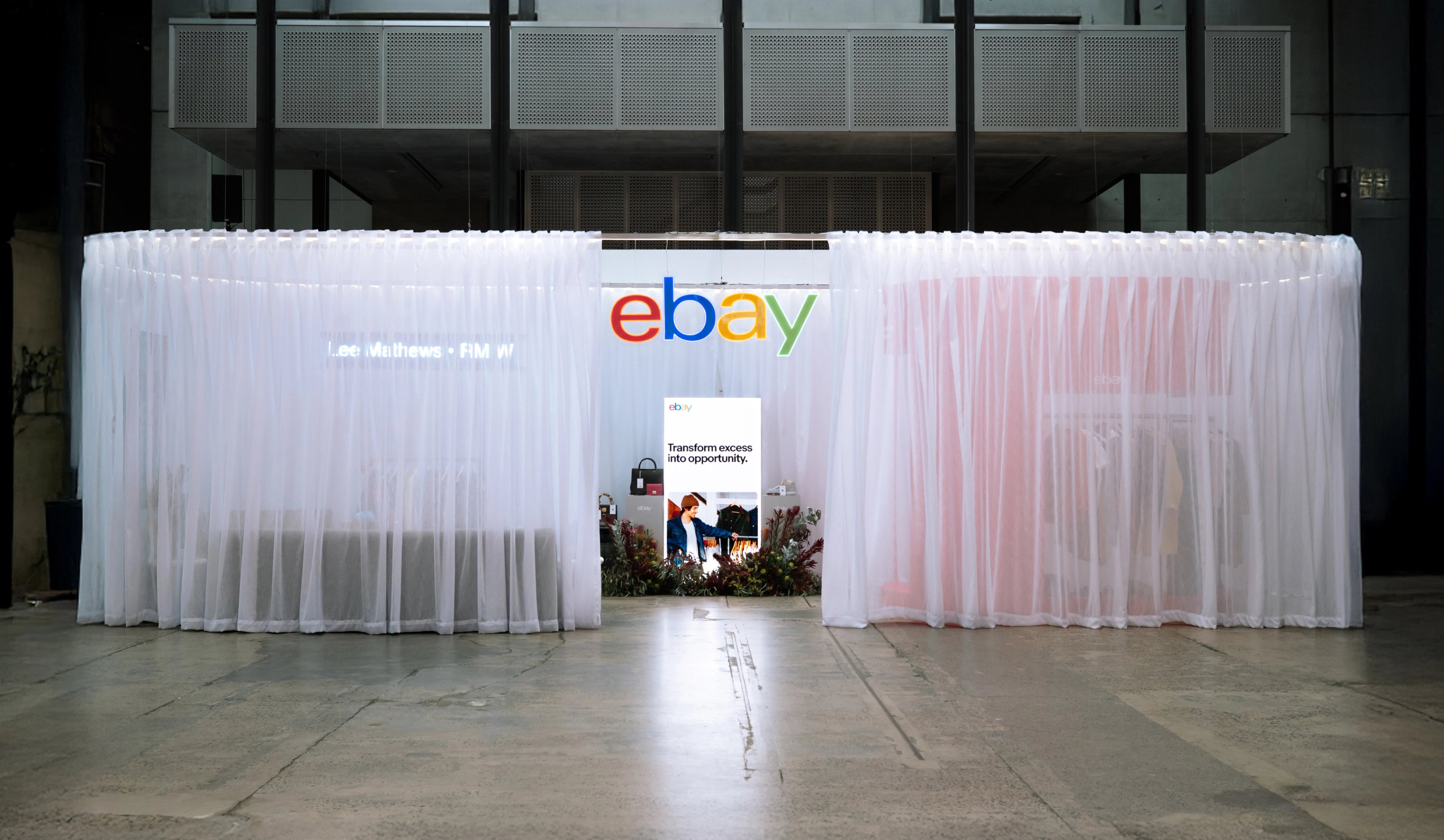 eBay pop-up installation at Australian Fashion Week with sheer white curtains and illuminated eBay logo