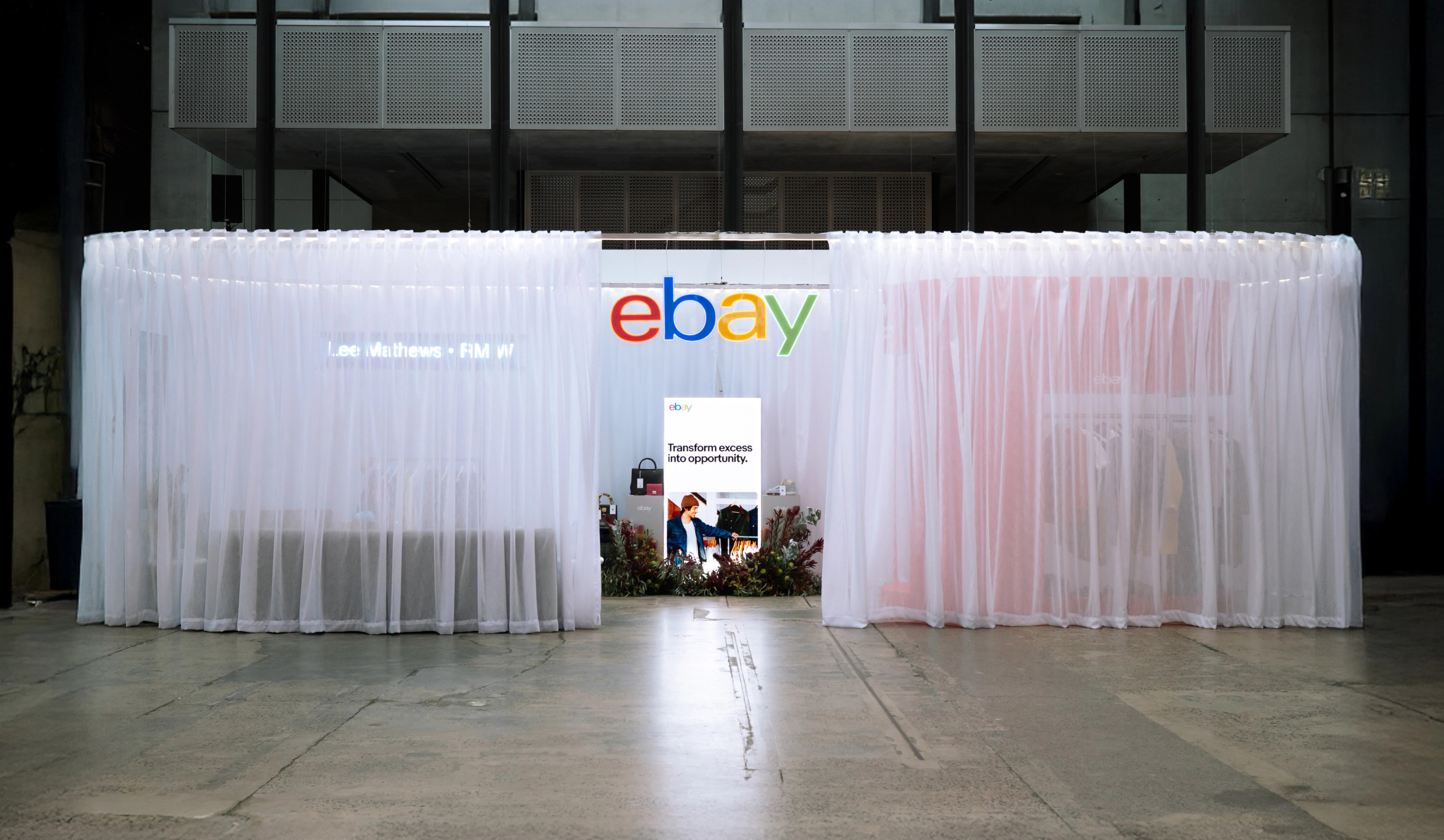 eBay pop-up installation at Australian Fashion Week with sheer white curtains and illuminated eBay logo