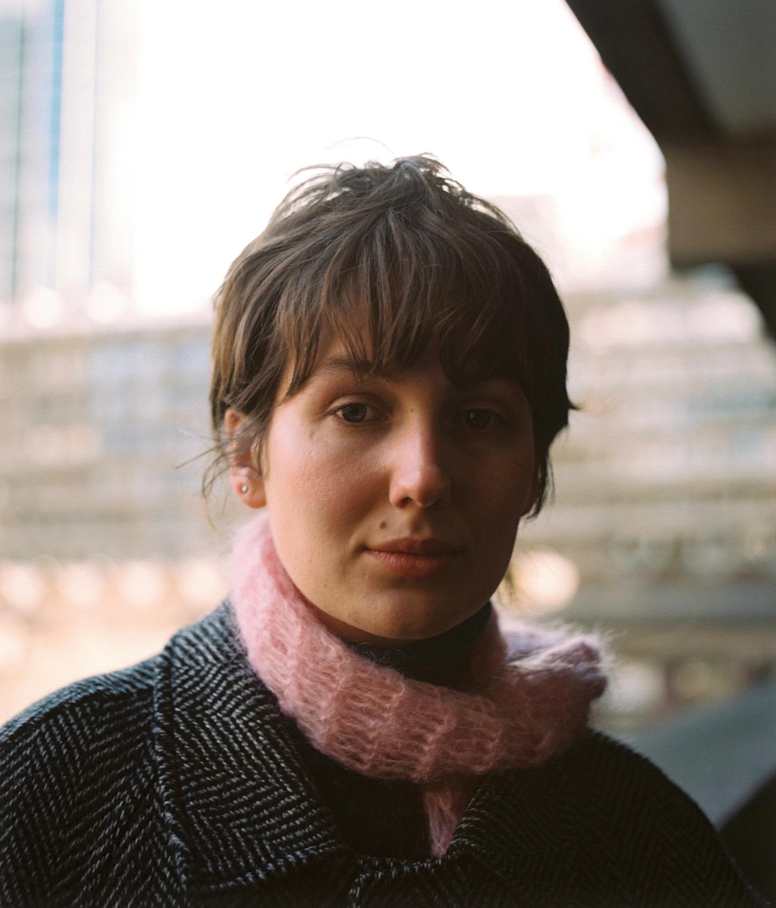 Mim Houghton in a herringbone coat and pink mohair scarf