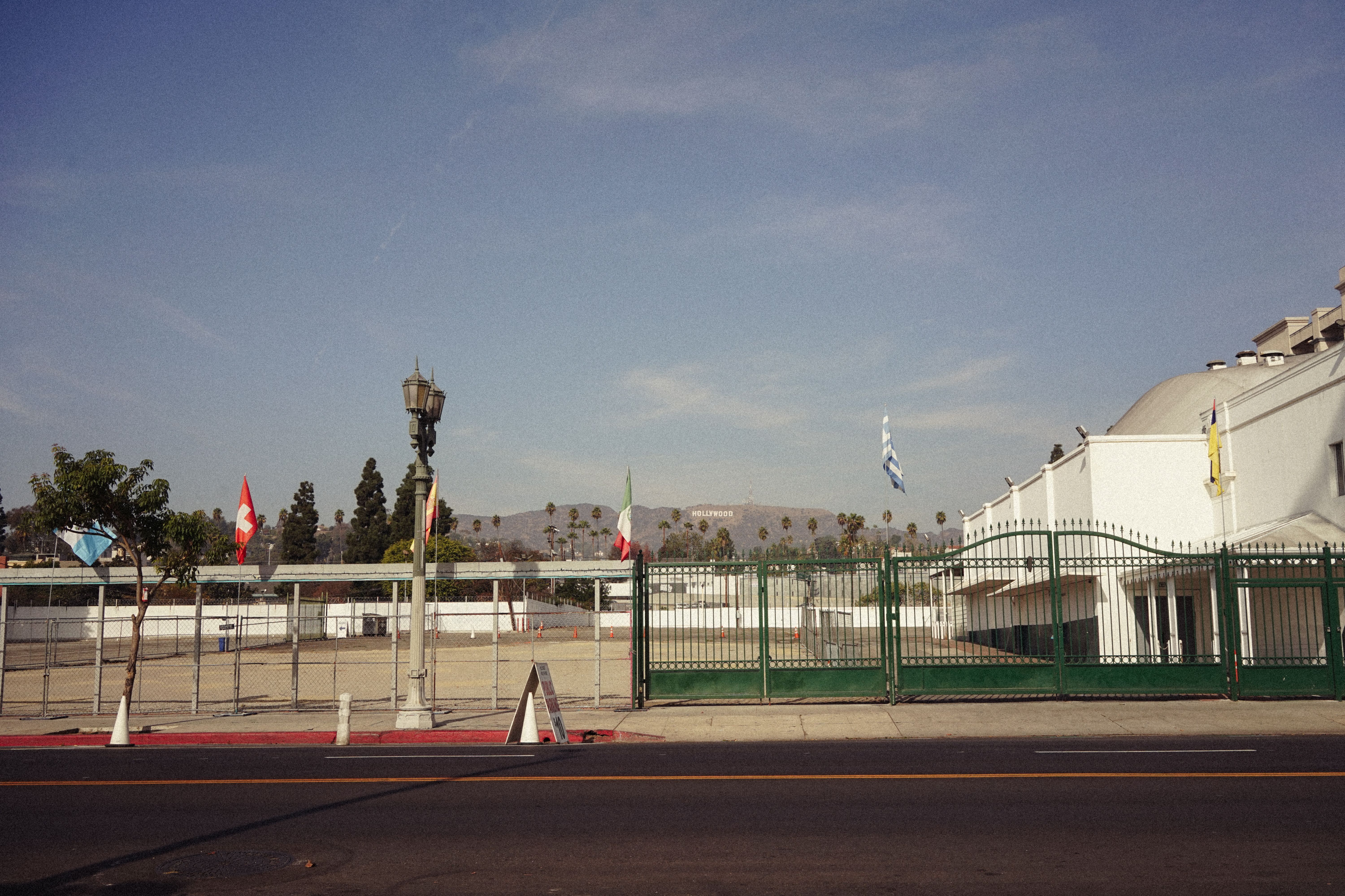 View of Hollywood Hills with flags and empty urban street scene.