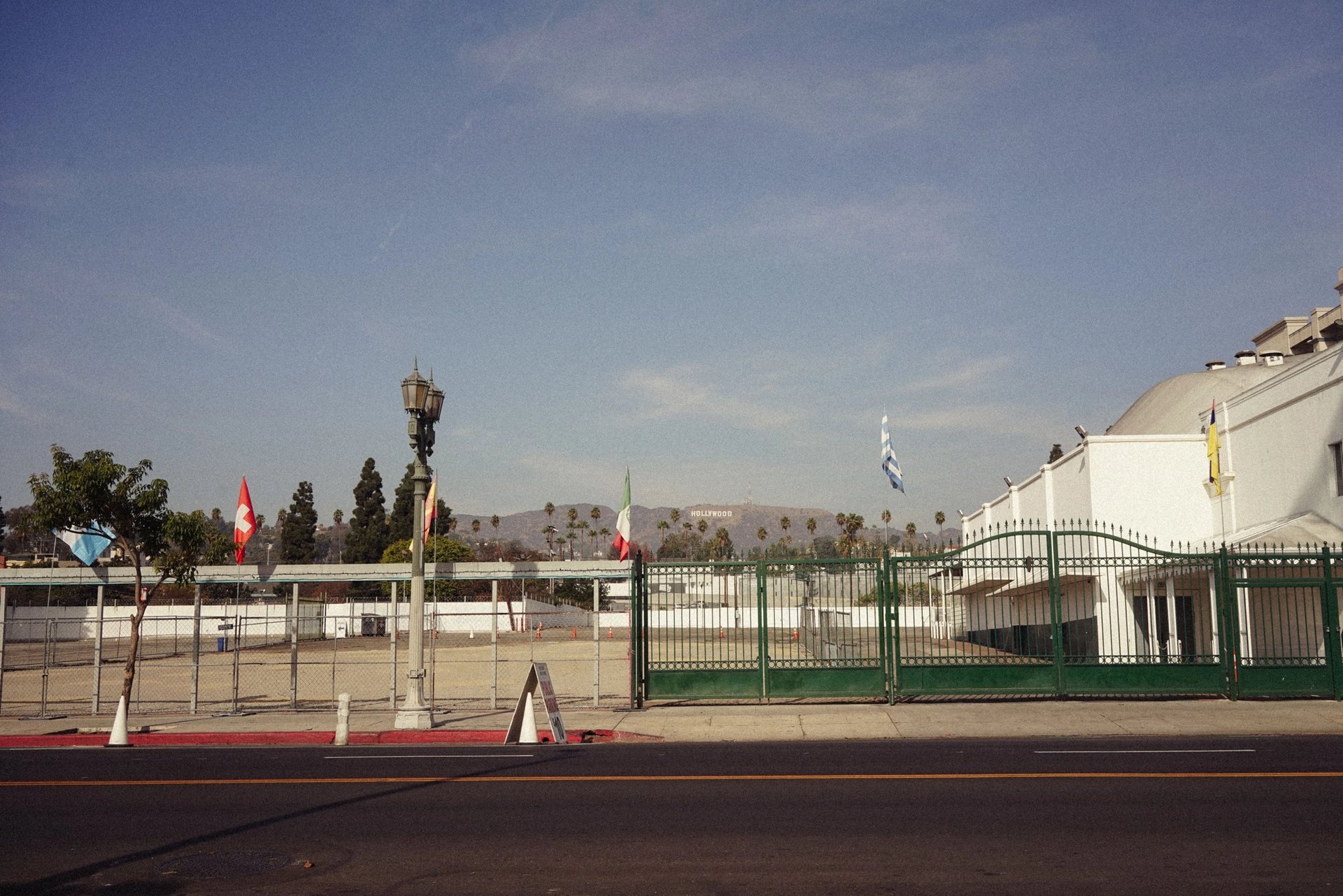 View of Hollywood Hills with flags and empty urban street scene.