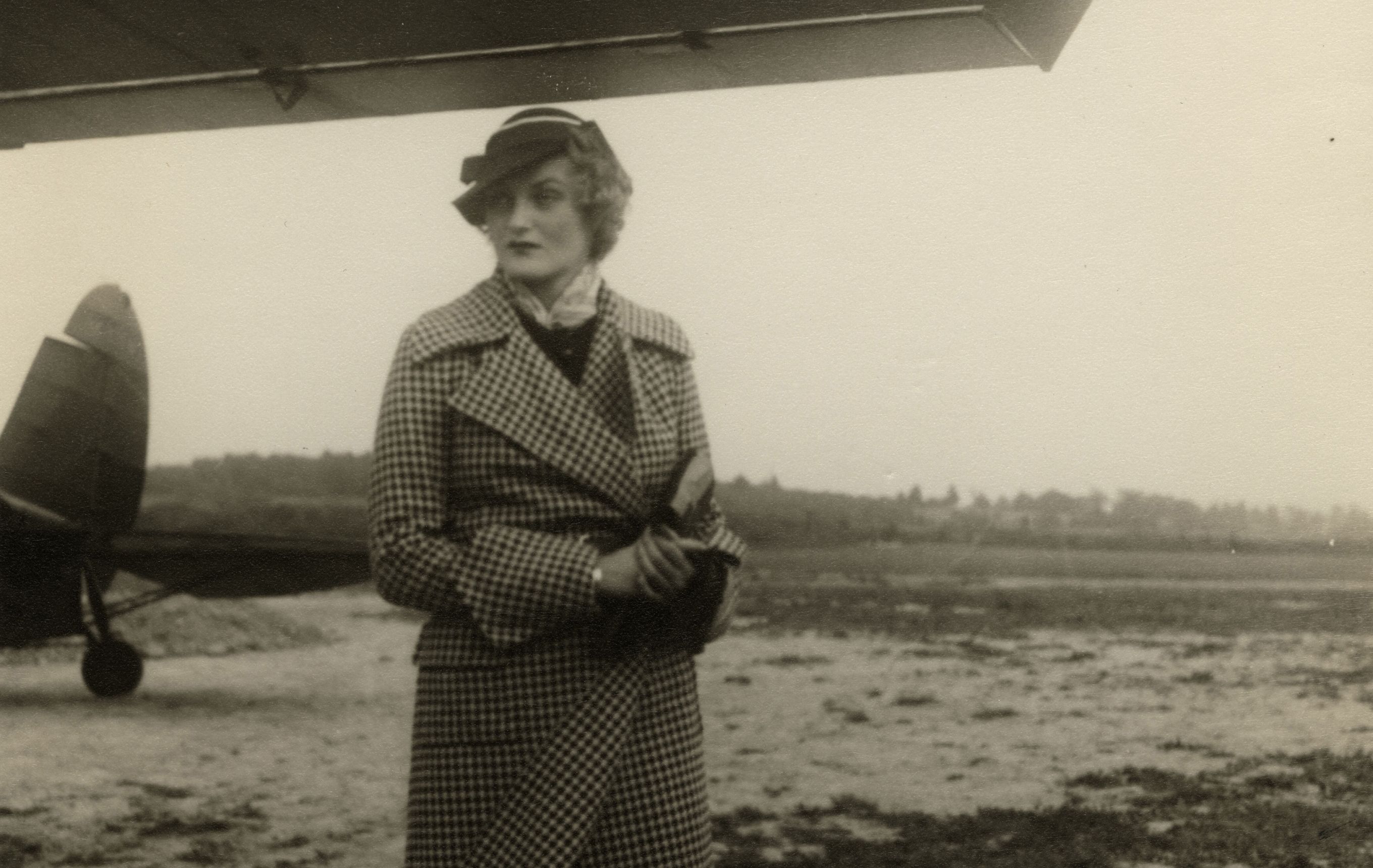 Doris Duke standing in front of a plane