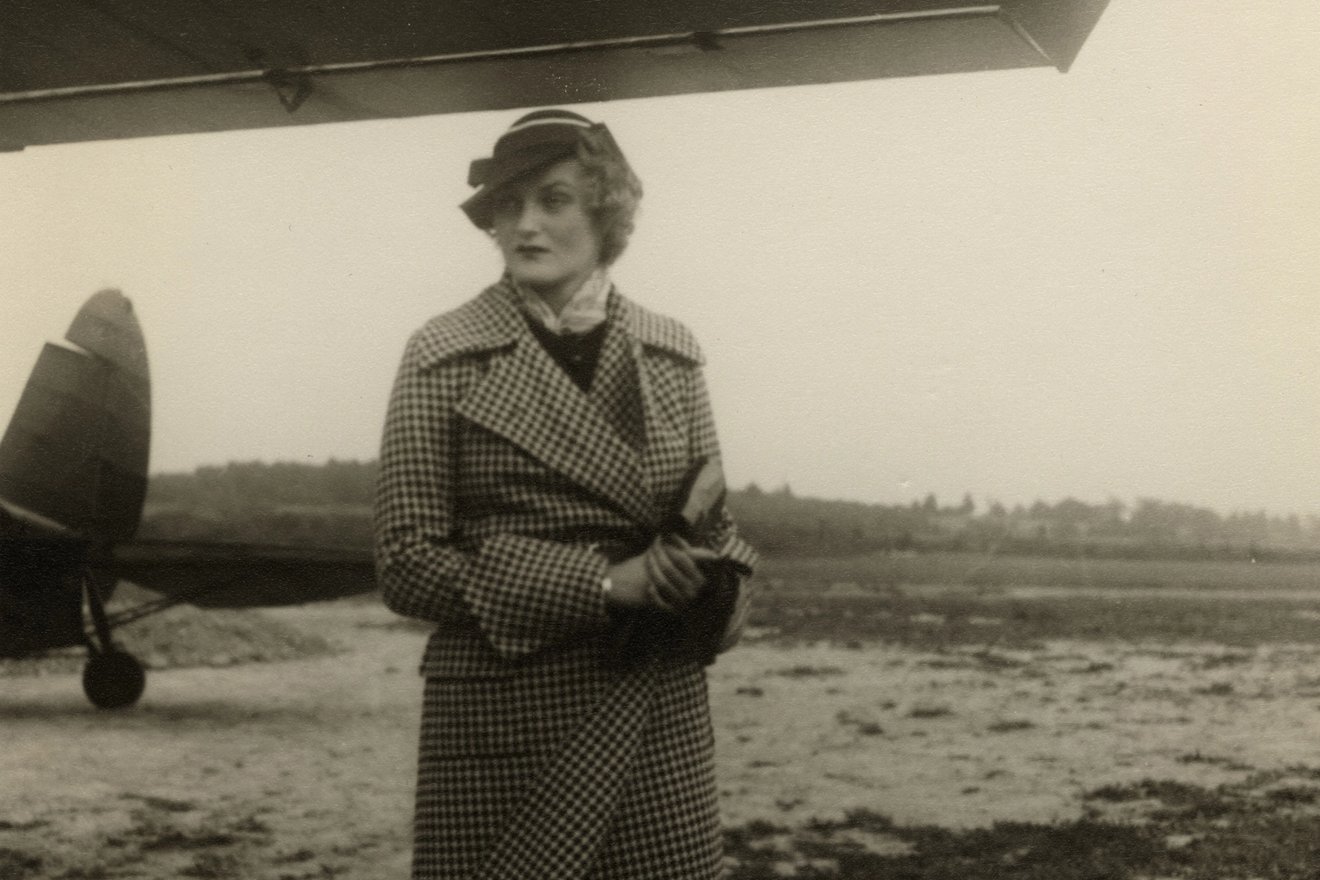 Doris Duke standing in front of a plane